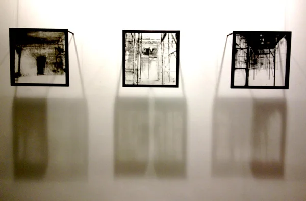 Liquid emulsion, hand printed onto glass panels and hung to cast a shadow evoking the many layers and traces of the history, destruction and survival of Vijecinica, Sarajevo, BiH