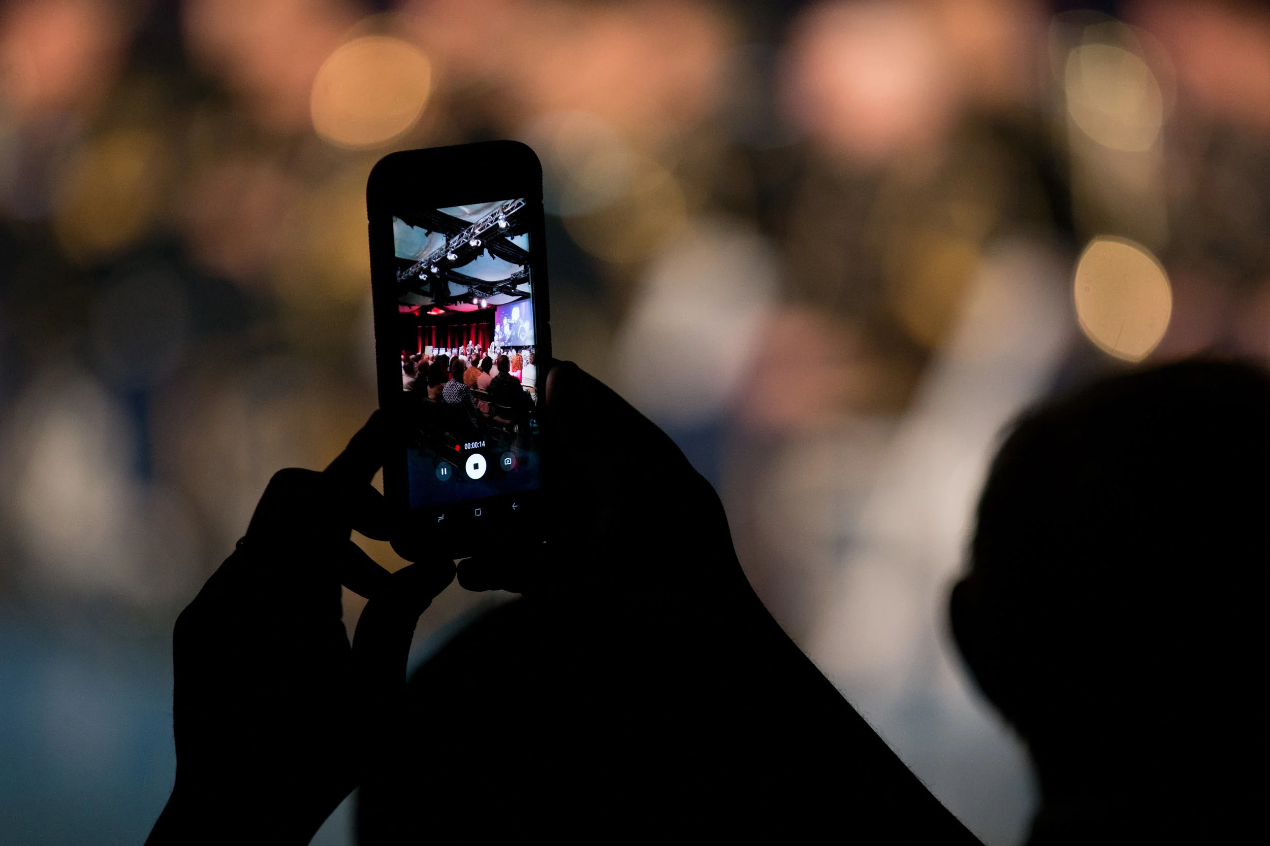 A concert goer records the performance with a cell phone at a U.S. Army Band concert in Arlington, Virginia. 
