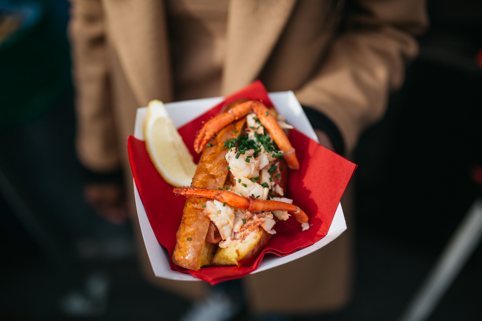woman holding lobster roll