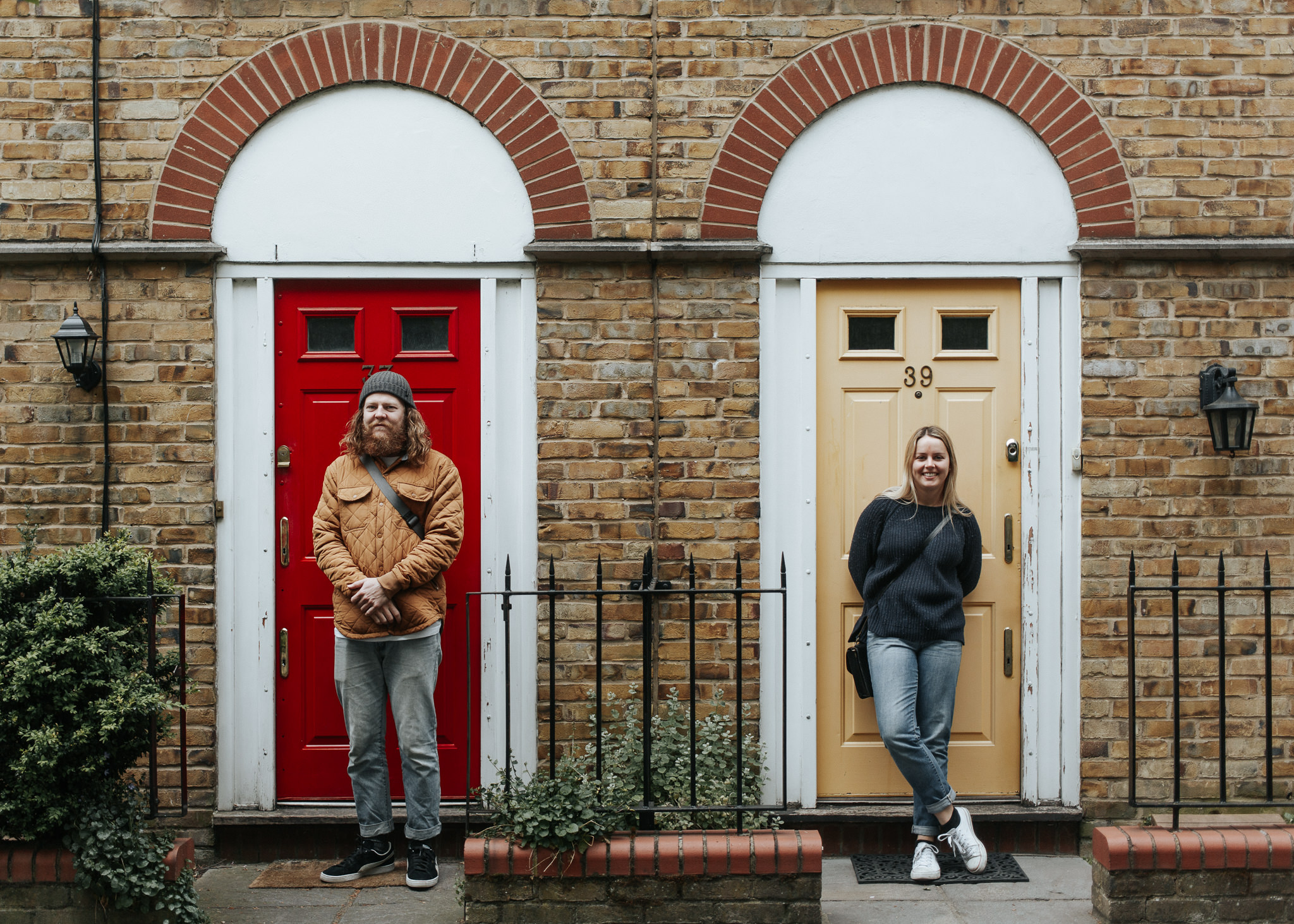 couple standing in front of colorful doors