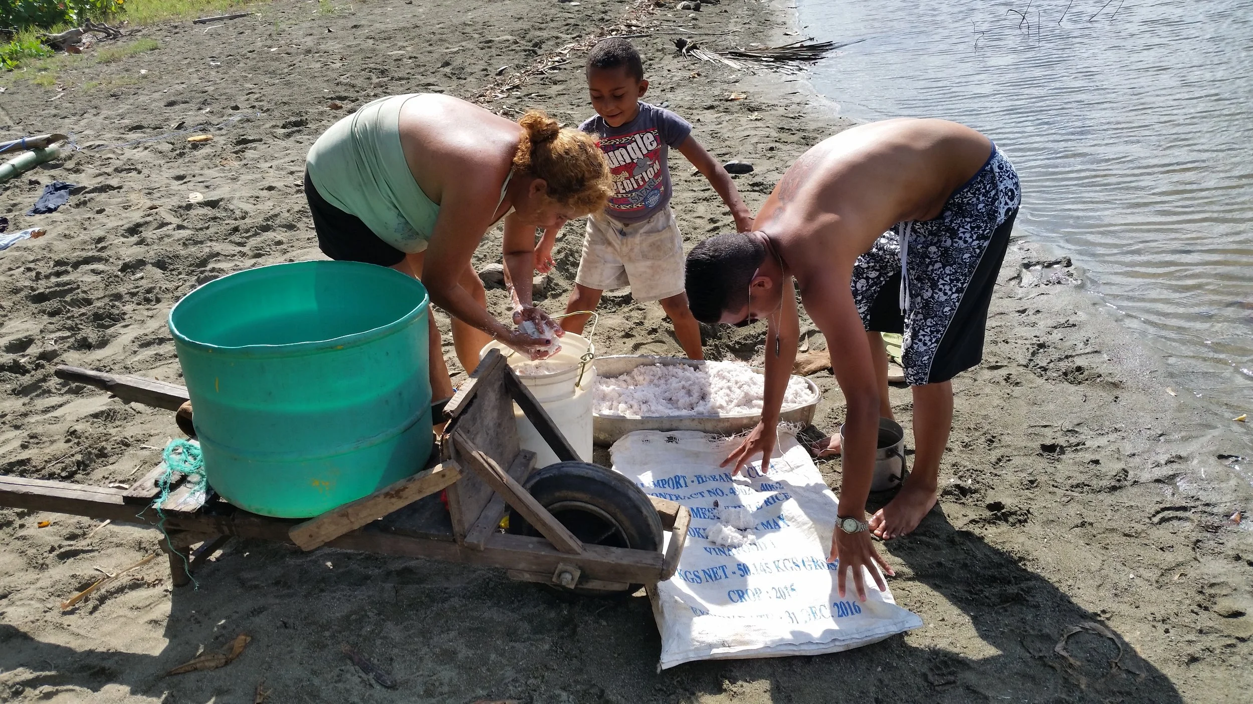 A family washes coconut to turn into cooking oil and beauty products