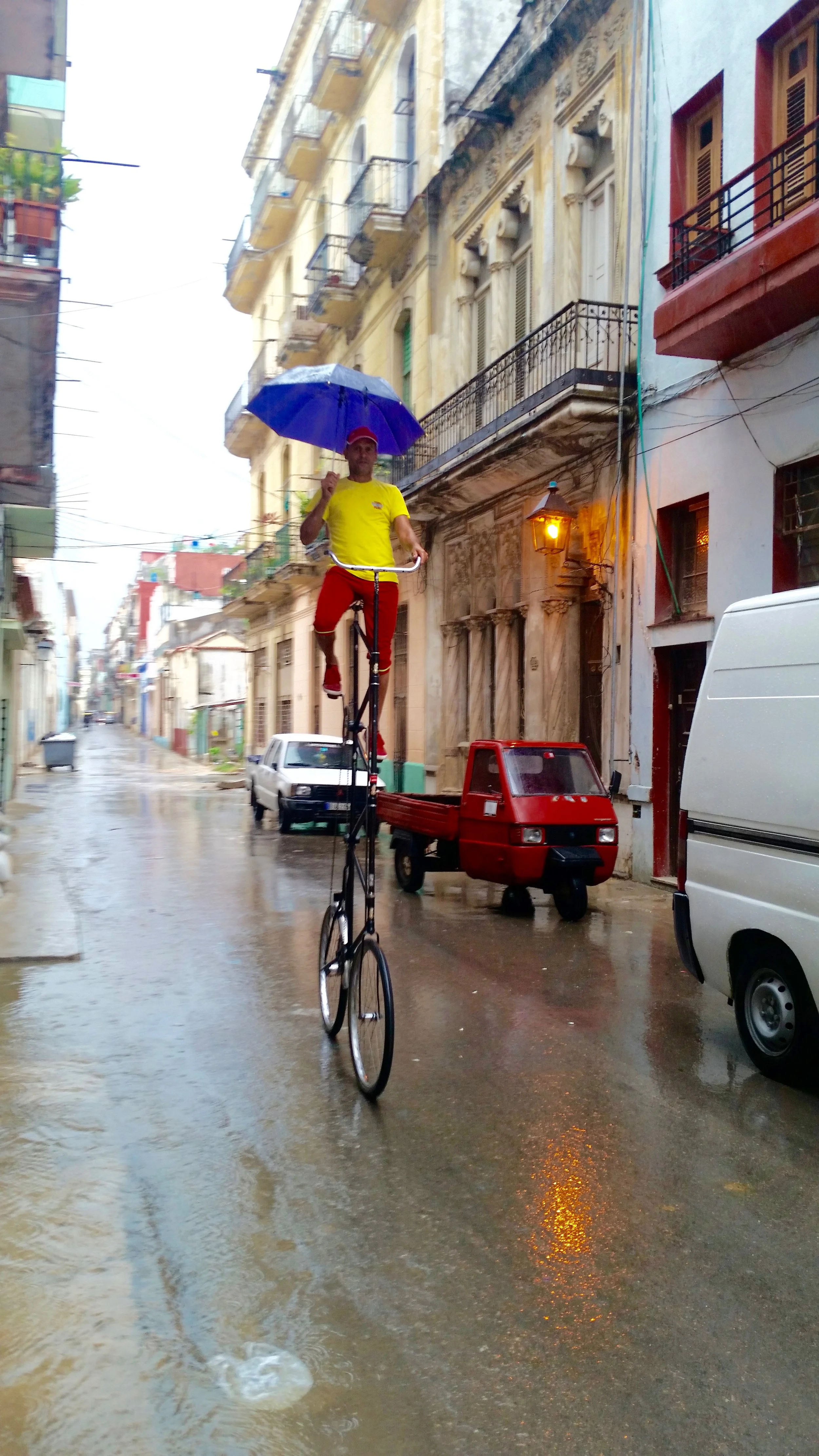 Felix Guirola riding his bike on a rainy day in Old Havana
