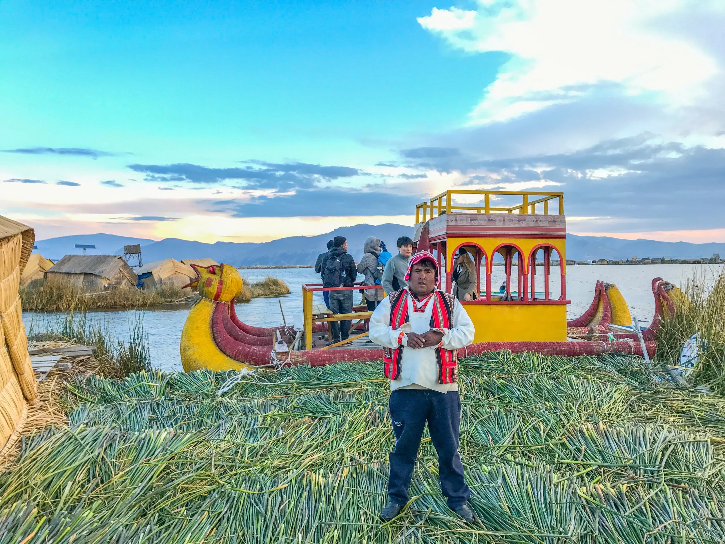 The Uros island chief posing in front of the Mercedes Benz boat in Puno