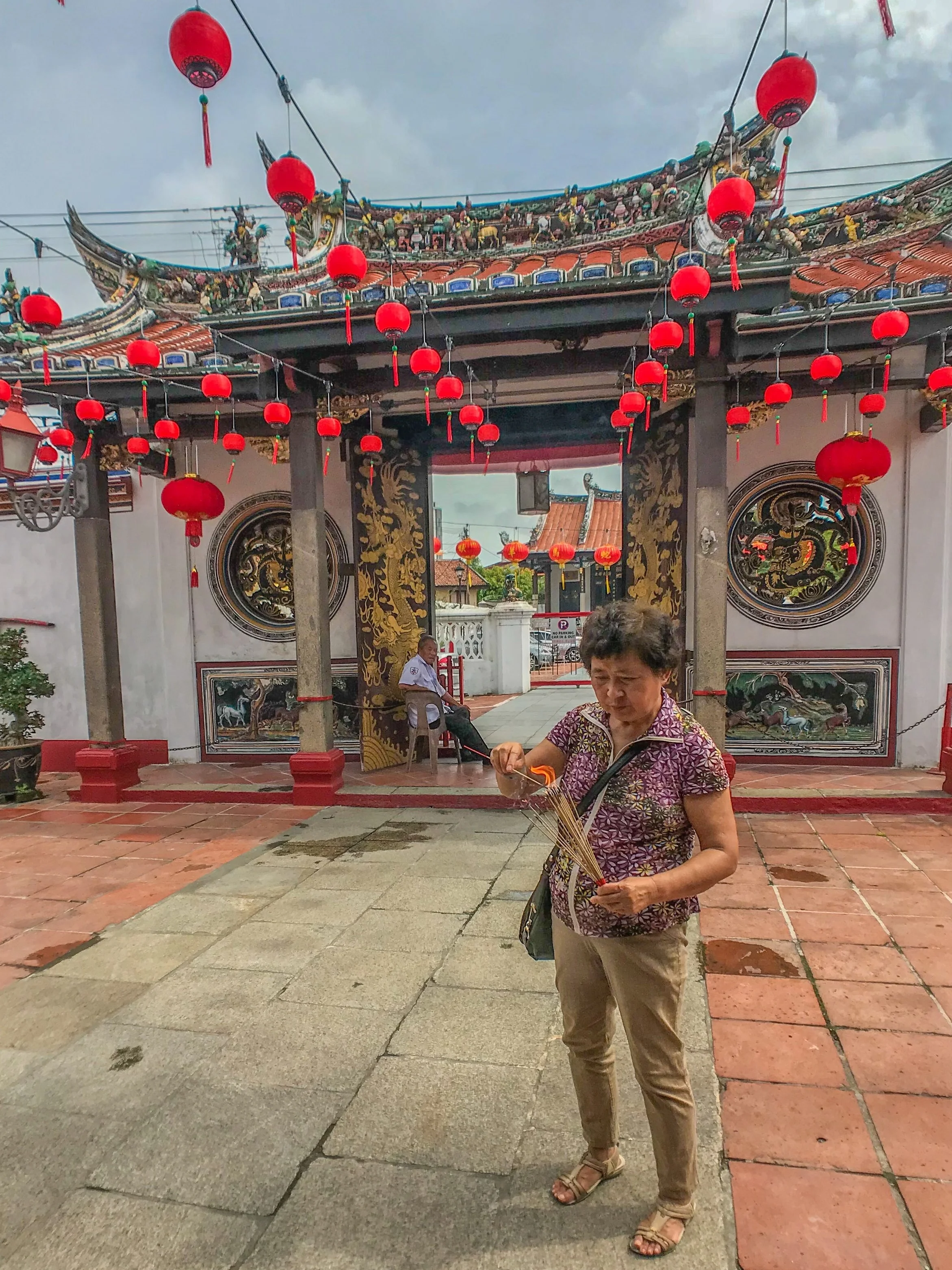Preparing an offering at a temple in Melaka