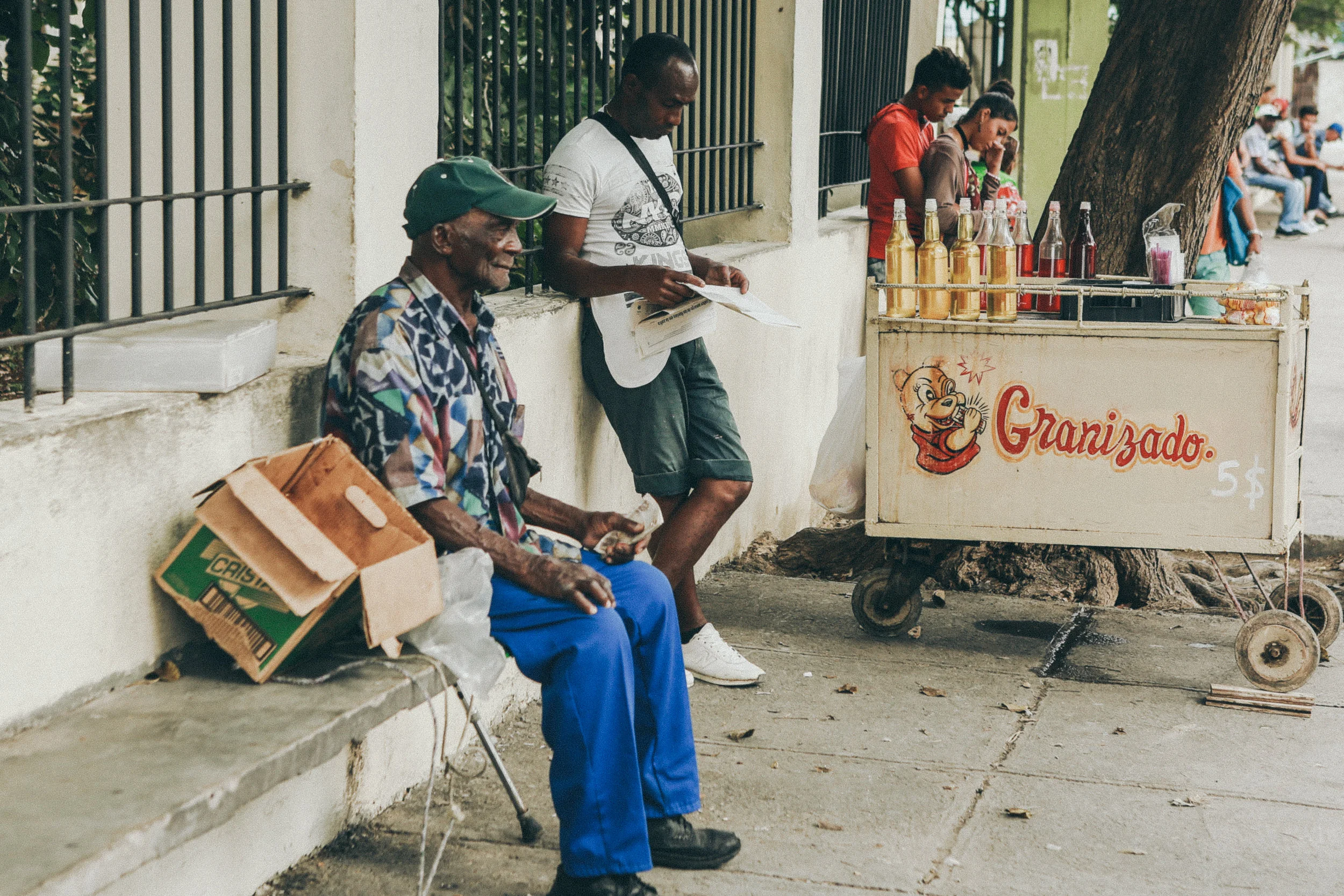 Street vendors selling produce and sugary desserts