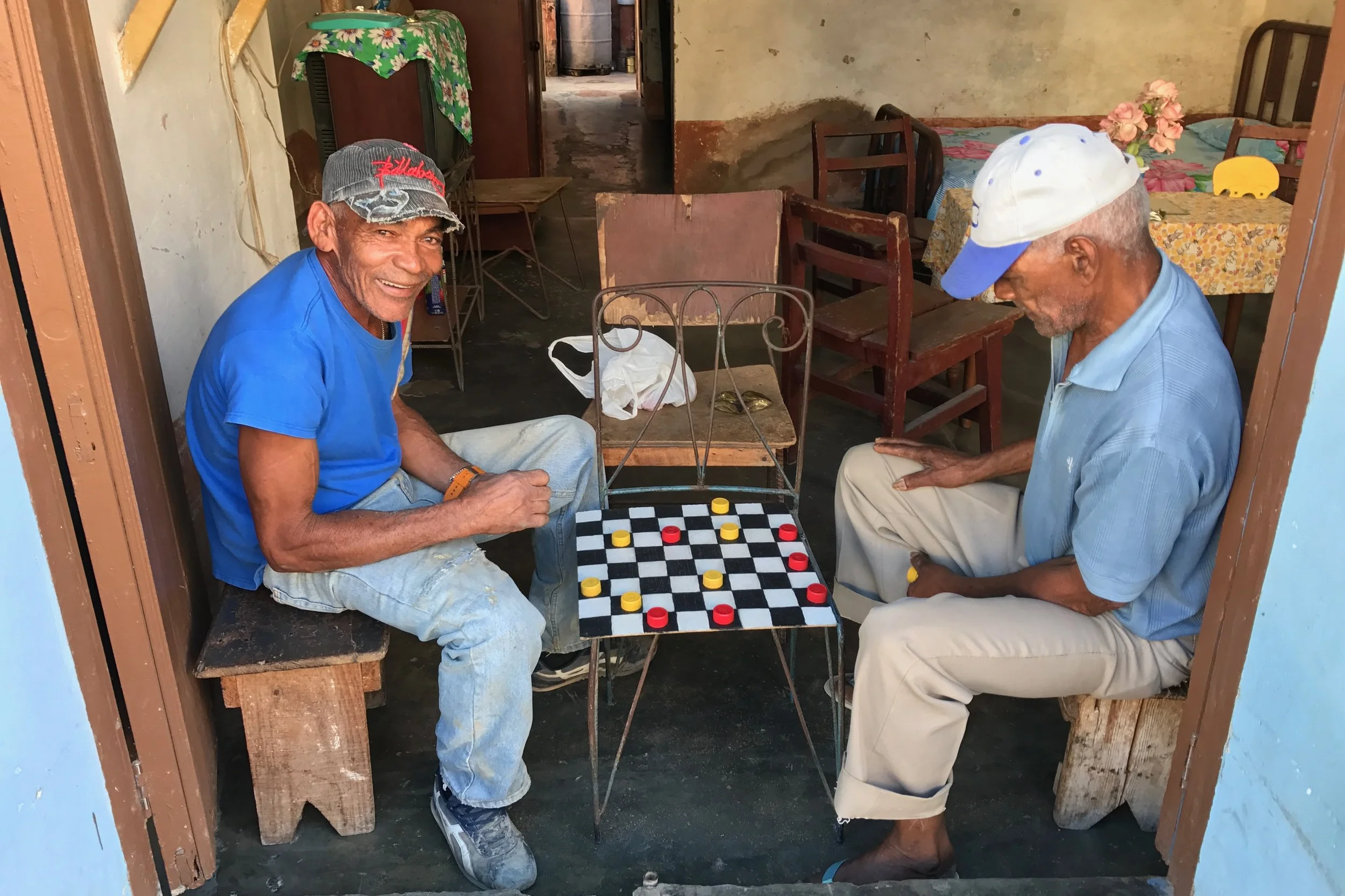 A game of checkers using ketchup and mustard bottle tops as the pieces