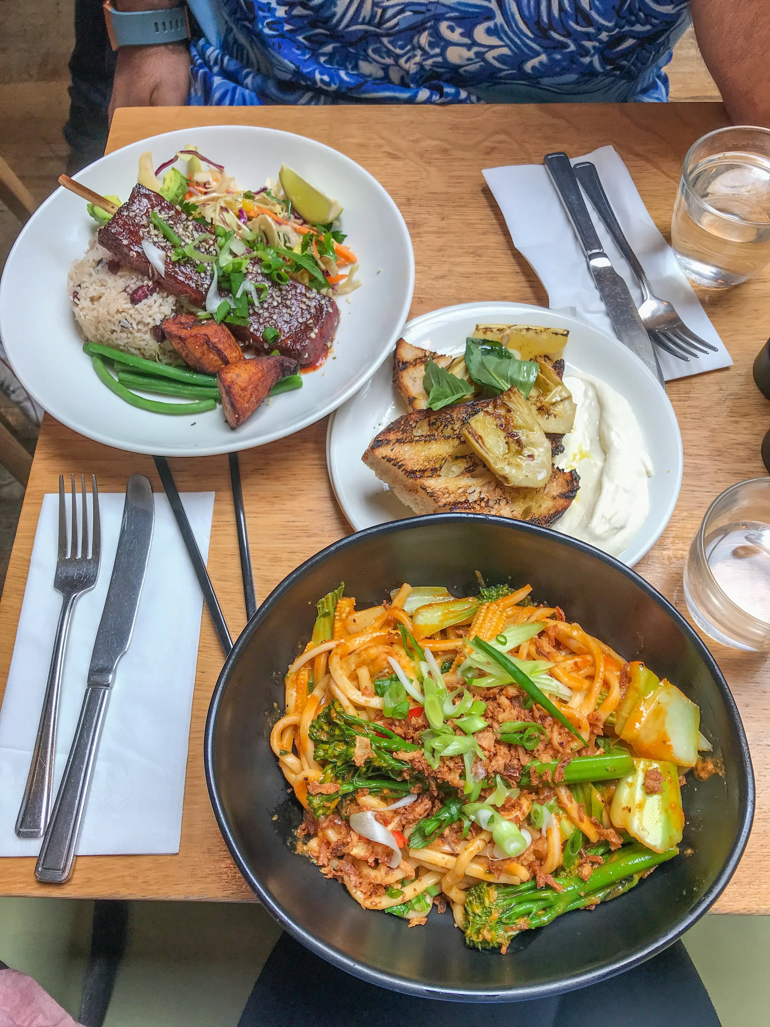 Gochujang noodles, jerk tofu, & artichoke toast at Mildred’s SoHo location.