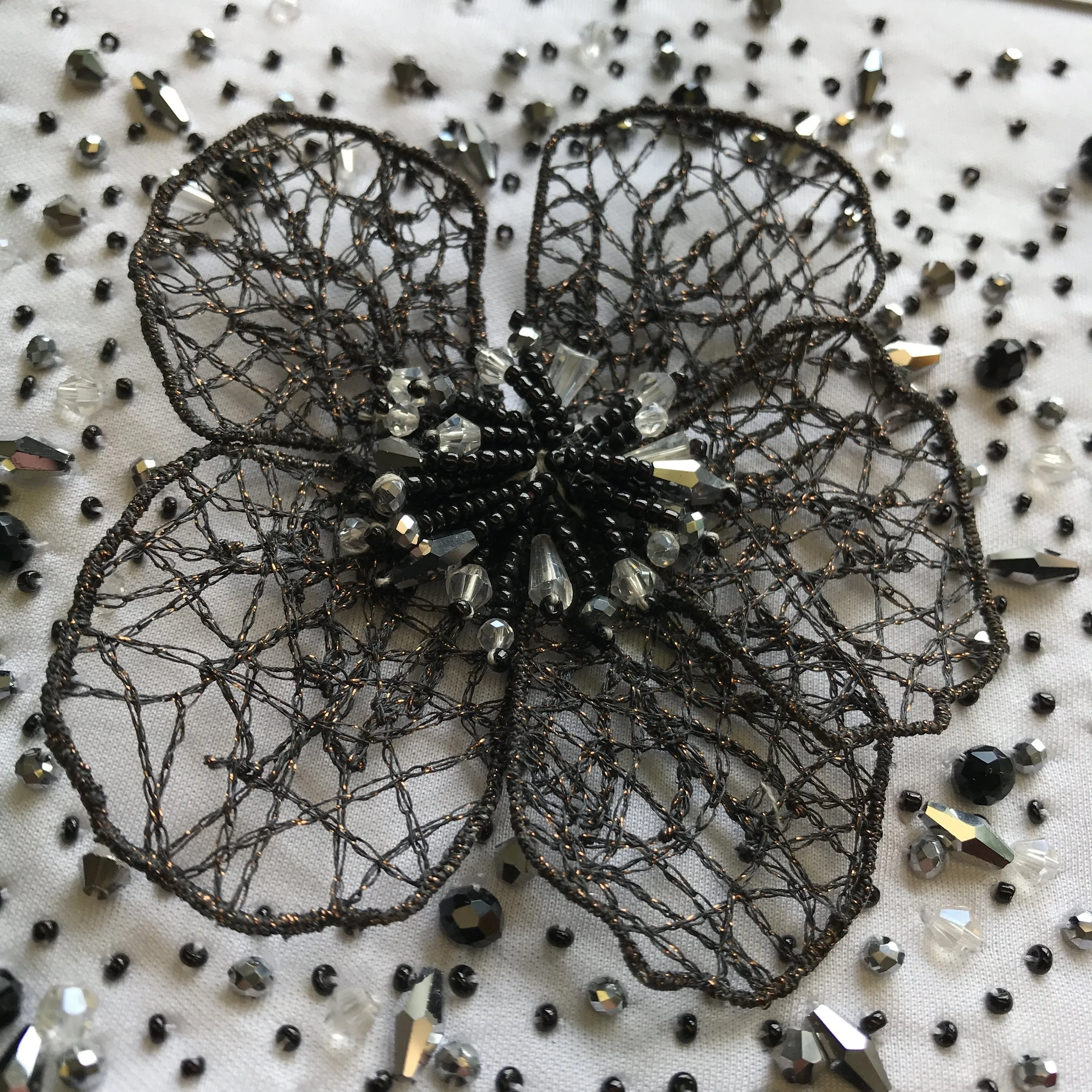 Hand embroidery by Rumi Embroideries India using POLY STAR and watersoluble foil SOLVY