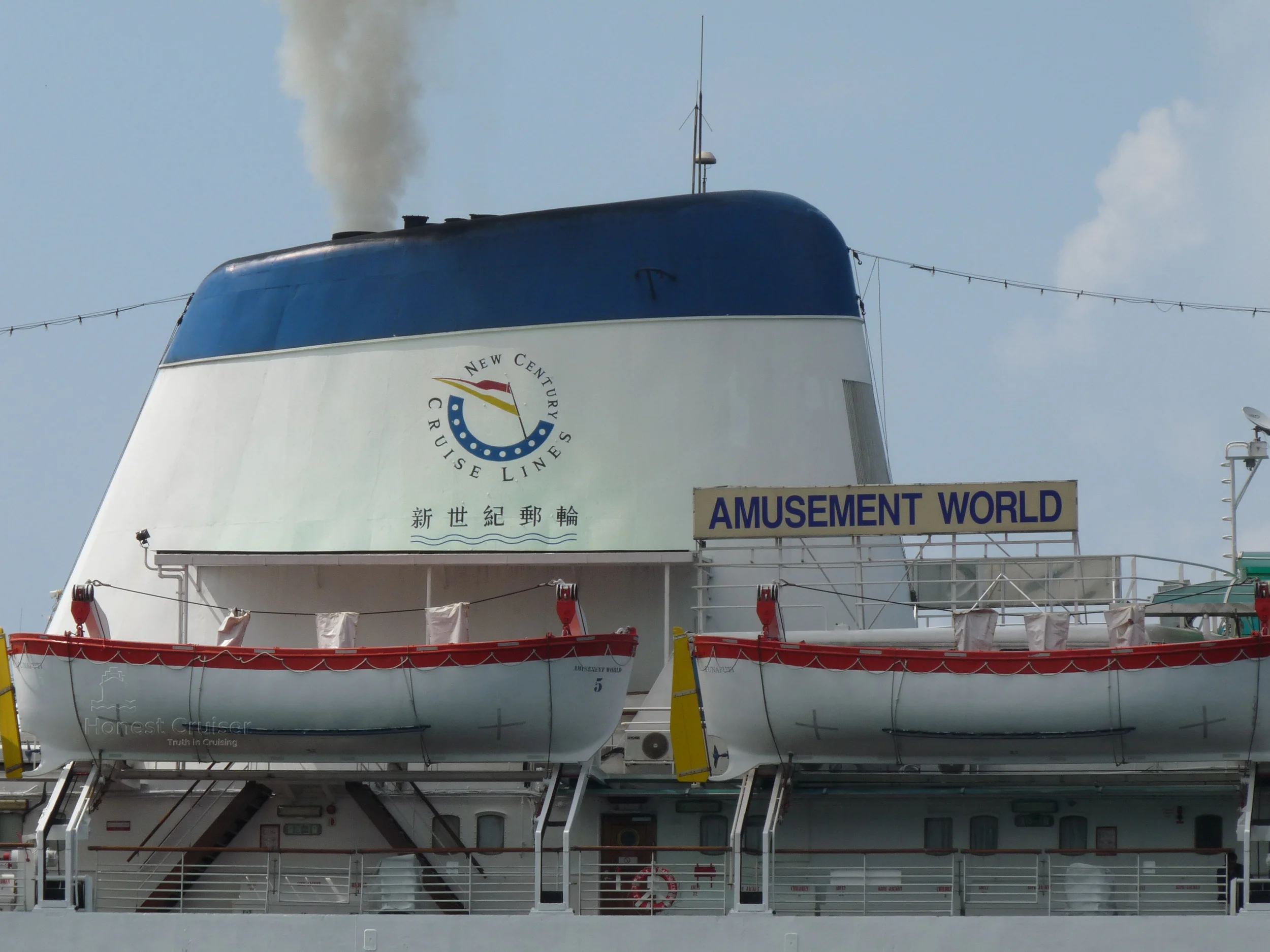 Amusement World's funnel in full use with New Century Cruise Lines logo prominently displayed.