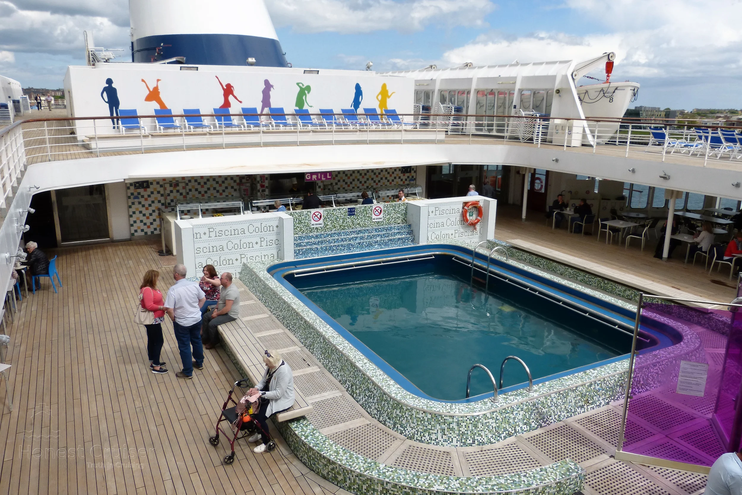 Silhouettes of colorful people adorn the base of the funnel and Spanish words can be seen on the decorative tiles at the back of the pool. Holdovers from Magellan's time with Ibero Cruises.