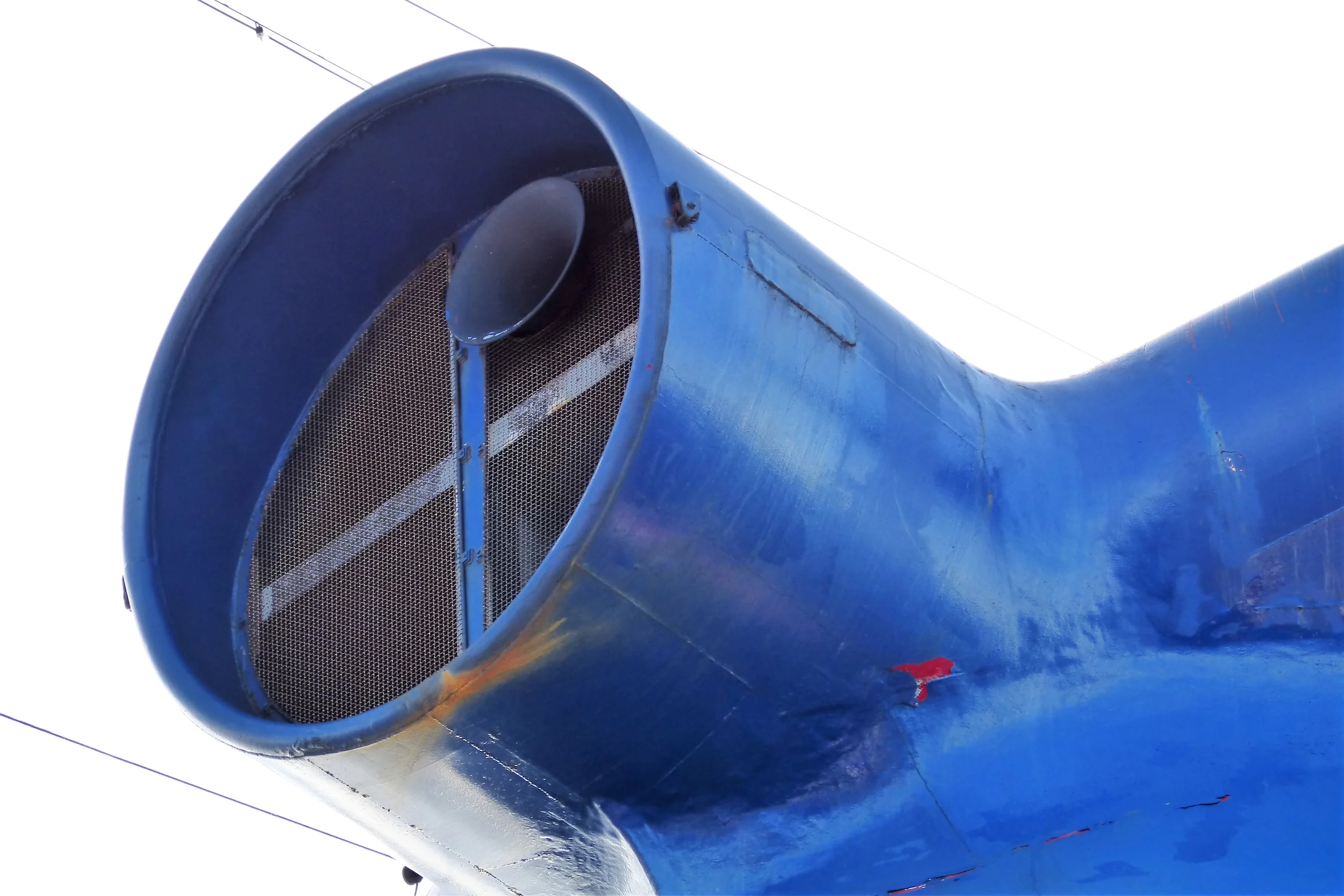 Under the funnel air intake, the blue paint is peeling to reveal the original Carnival red.