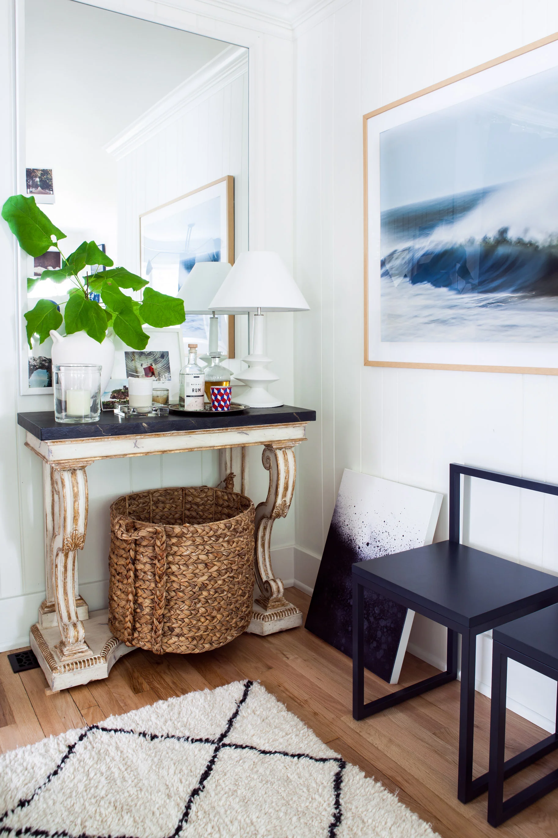 As a fan of seaside living, Michelle gravitates toward art depicting water. Above in her living room she pairs Waves with Spray by Greg Anthon with Escape by Elaina Sullivan . Photo by Marta Xochilt Perez . 