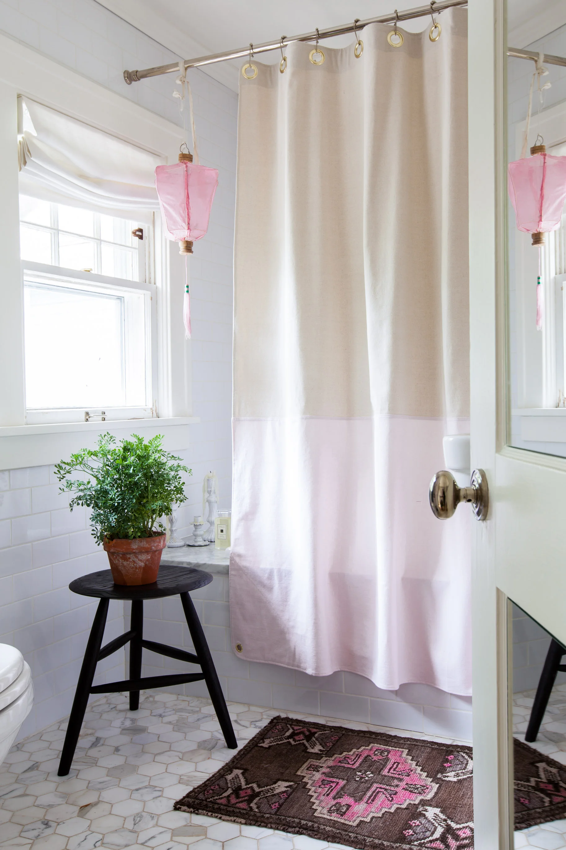 Heated floors and tons of natural light make Michelle's master bath one of her favorite rooms in her house. Above the bath hangs a lantern that she purchased in college and has since moved with her to eleven apartments and one home. "I can't seem to part with it. It's such a cheerful piece!" says Adams. Photo by Marta Xochilt Perez