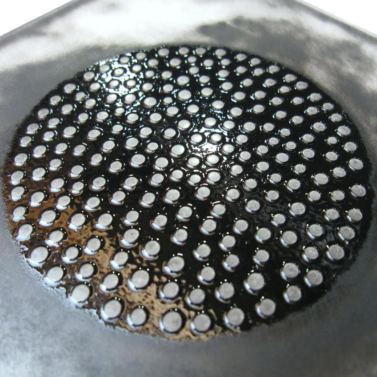 A matrix of sculpted miniature dots, inked and ready to print.