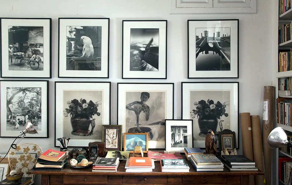 Inside the West Village home of Joy Sohn and Oberto Gili , framed photos from Gili’s trips to Sri Lanka, Hong Kong, and Comacchio, Italy, line the walls. Photo by Joy Sohn via Domino . 