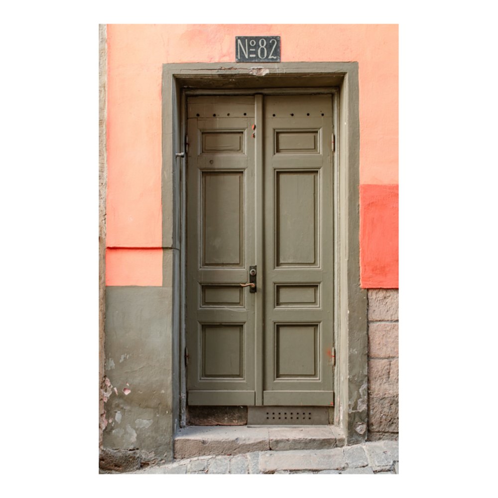 Peach building with green door in Gamla Stan, Stockholm by Manon