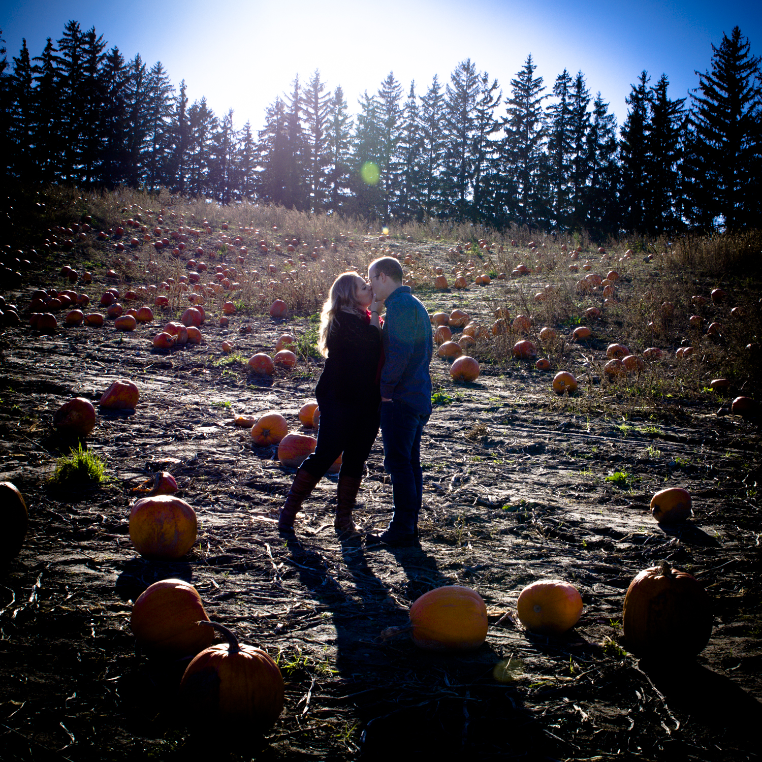 October fall engagement photo with pumpkins