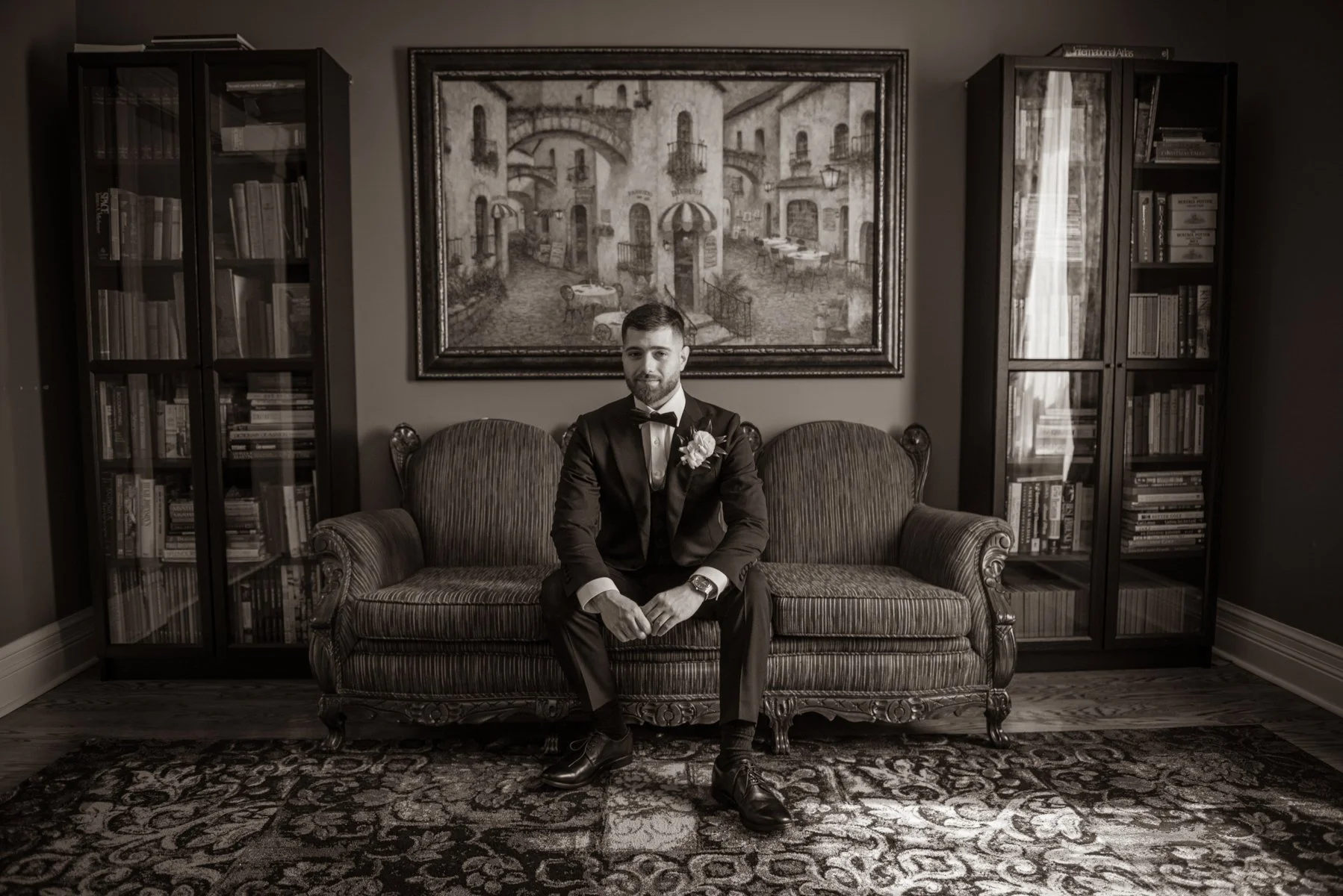 Michael, in the house where he was born.
Some portraits aren't about the suit or the light. They're about the story sitting behind the subject &mdash; bookcases his family filled, an Italian piazza painted on the wall, a quiet moment before the day b