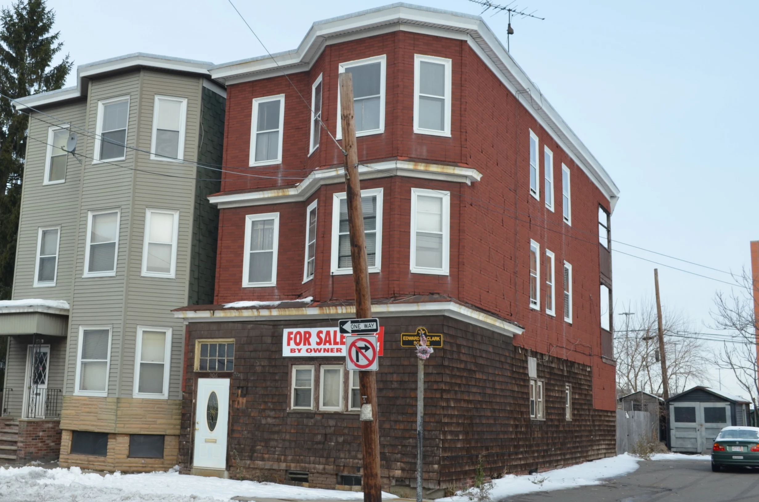 The home was sided with fake brick and worn-out shingles.