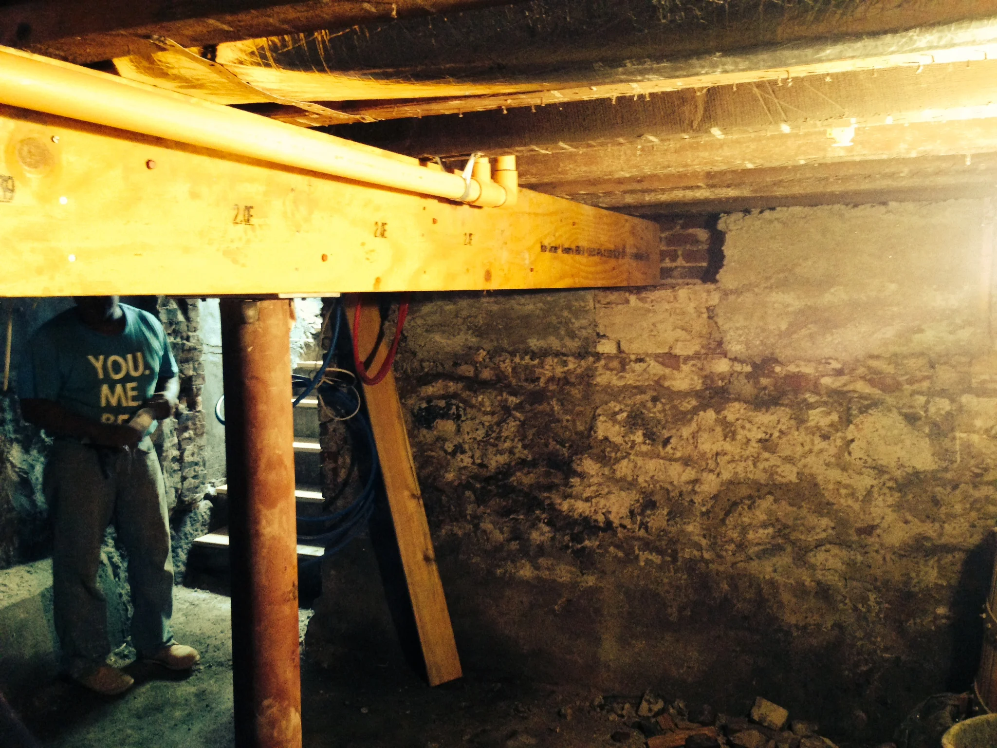 The new concrete in the upper right of this picture was piped into this basement through a 3 foot wide walkway between this home and the next door neighbors. 