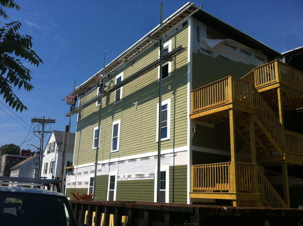 We sided the house in a two-tone green siding and added a staircase to the exterior deck so that we could remove one of the interior staircases , creating more square footage indoors.