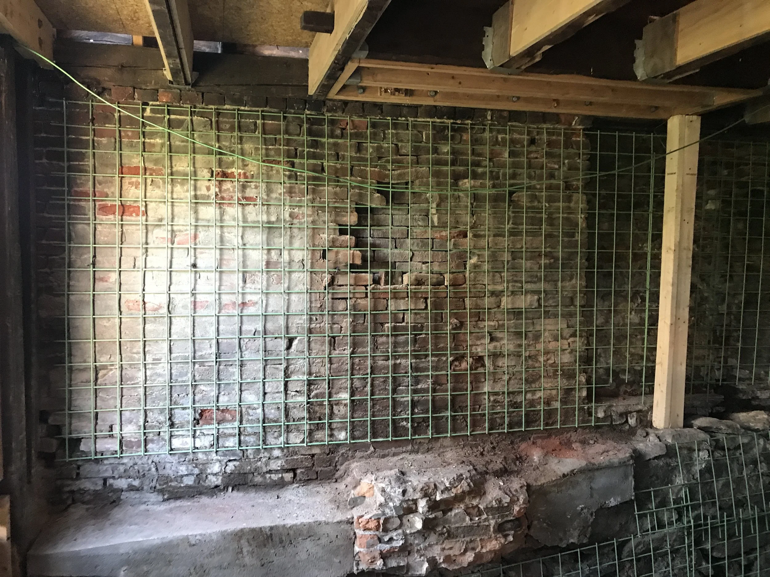 We decided to use reinforced rebar sheet and 3-4 inches of 7500 PSI shotcrete in order to rebuild and stabilize the foundation.