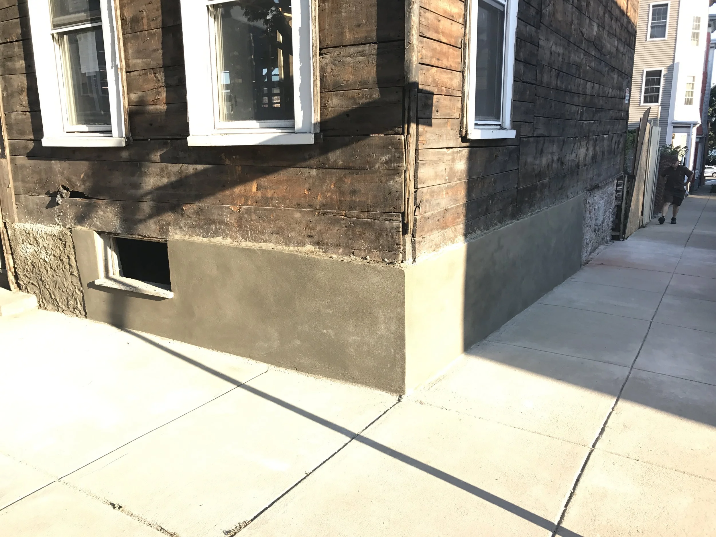 After the brick is rebuilt, the entire foundation gets a brown coat and a smooth coat of stucco!