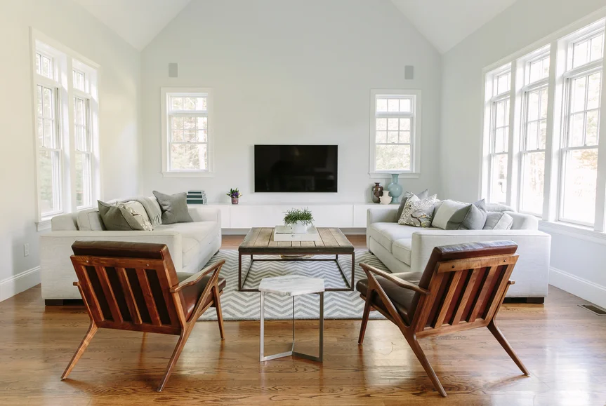 Hardwood floors and white walls make this living room with transitional modern furniture feel open and spacious.
