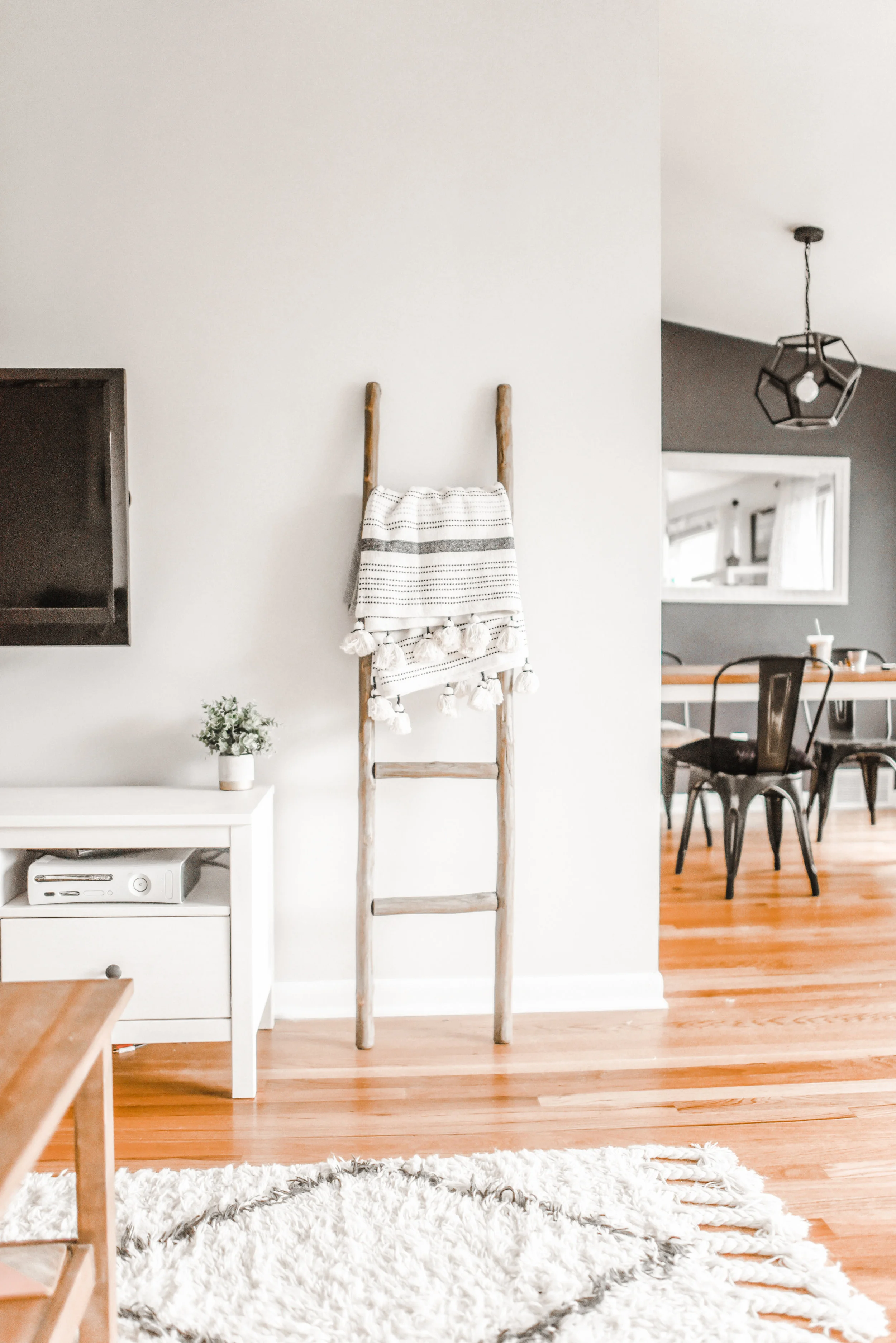 Hardwood floors and white walls flood this home with natural light designed by Elegant Simplicity Interiors.
