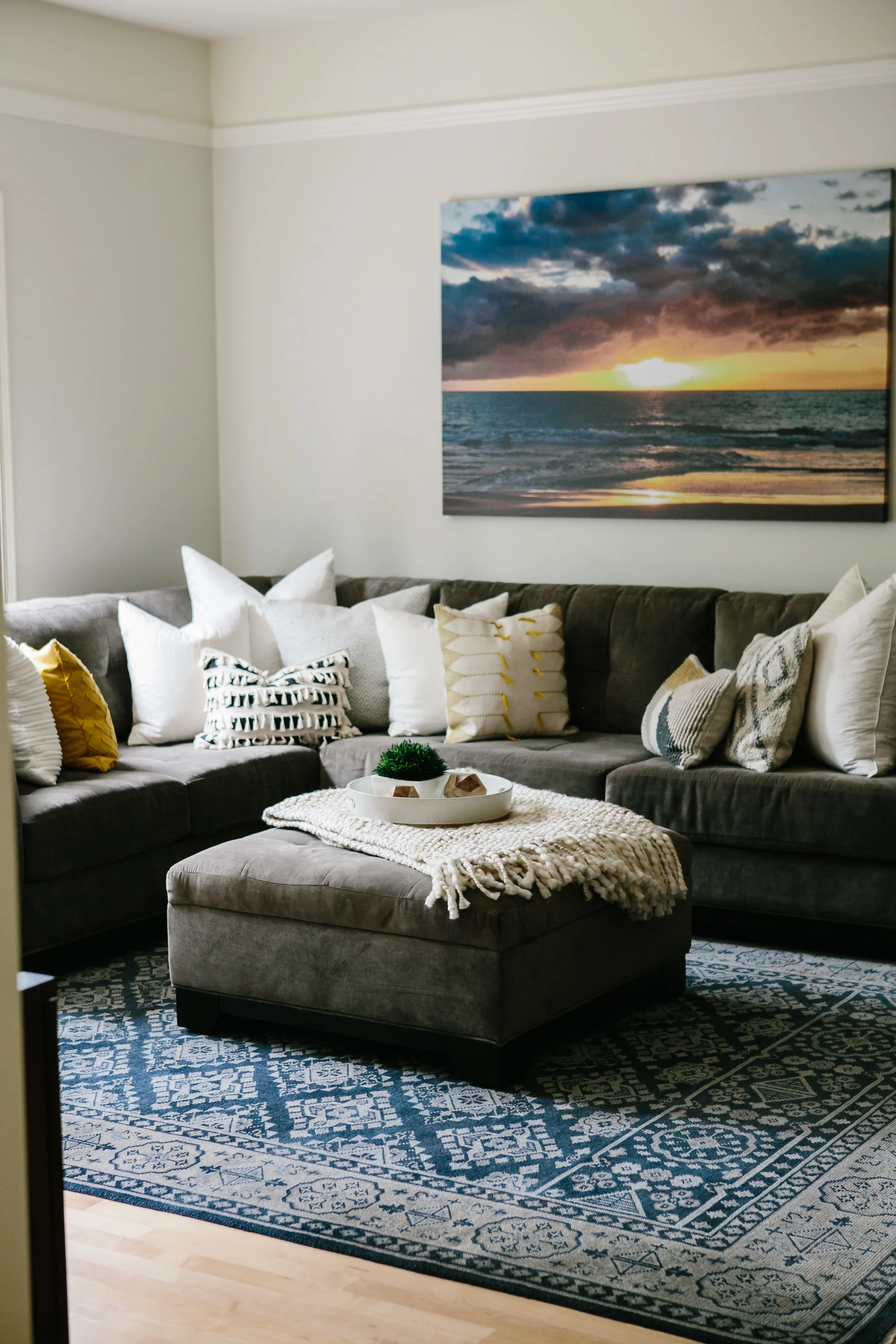 An oversized section from crate and barrel with an ottoman in a modern classic living room designed by Elegant Simplicity Interiors.