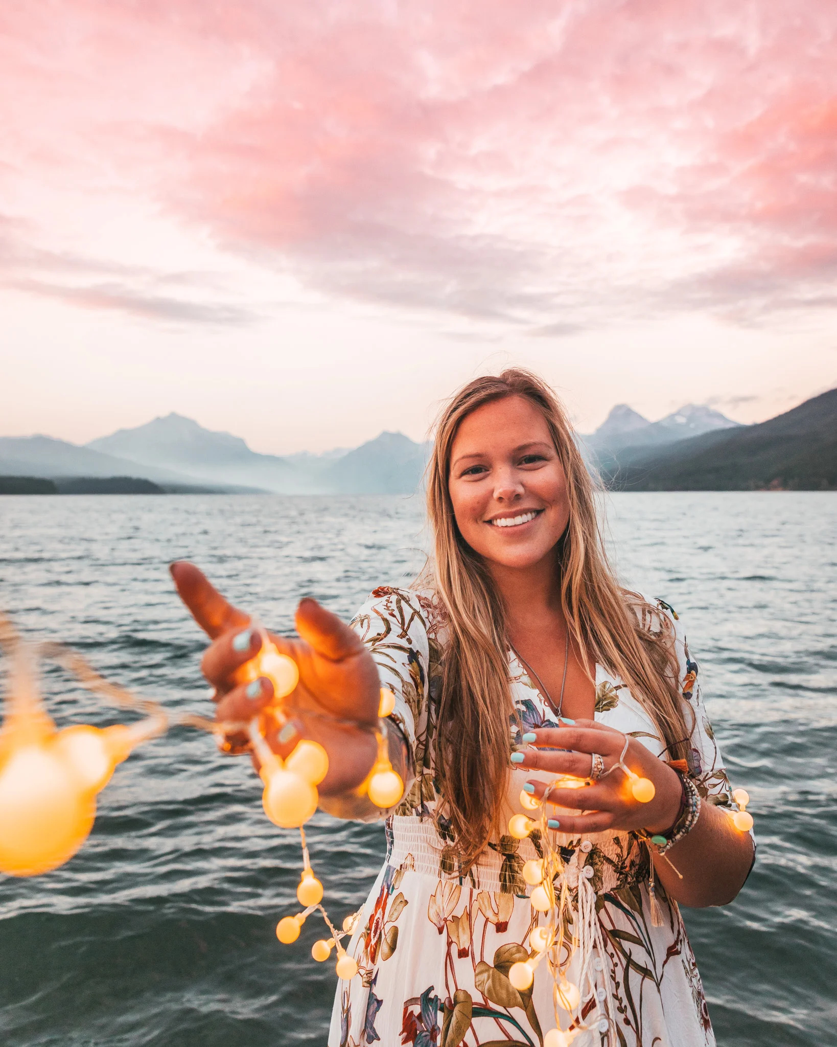 Pink sunset follow me to photo at Lake McDonald in Glacier National Park Montana with fairy lights