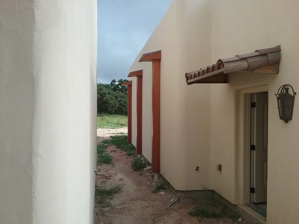 A house featuring a central door flanked by a window on each side, showcasing a simple architectural design.