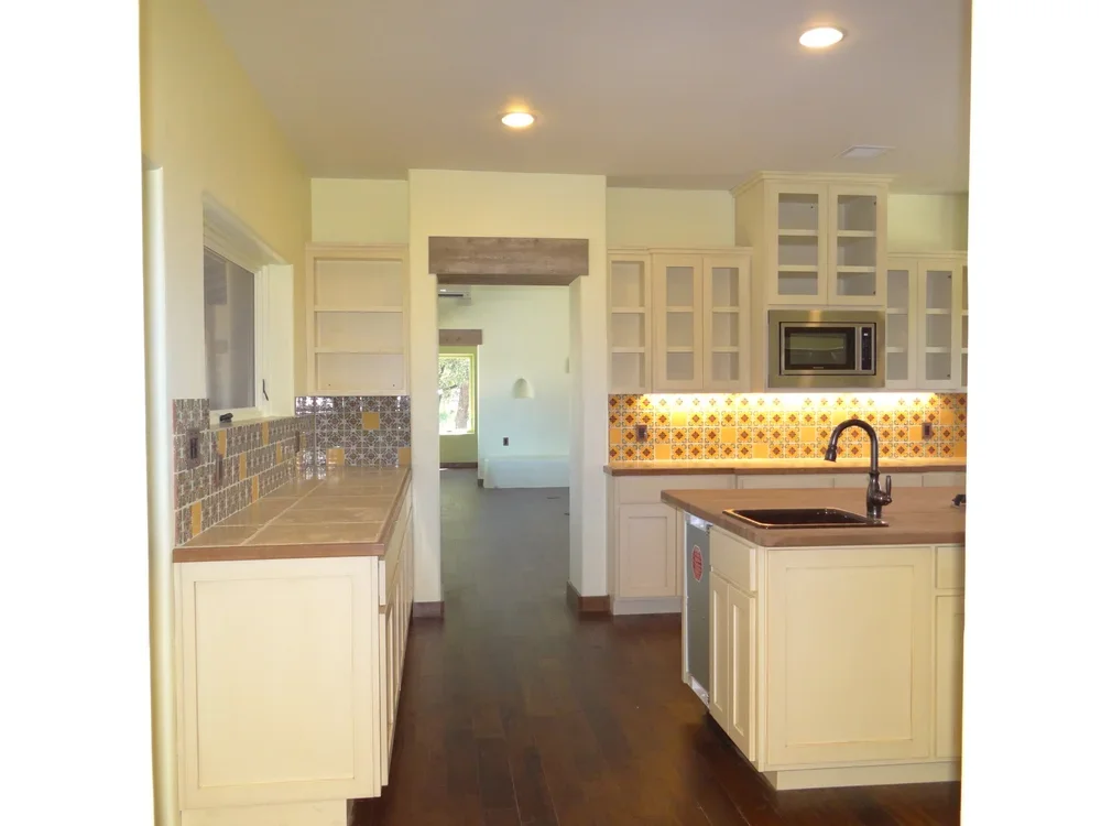 A modern kitchen featuring a sink, stove, and refrigerator, showcasing a functional and organized cooking space.