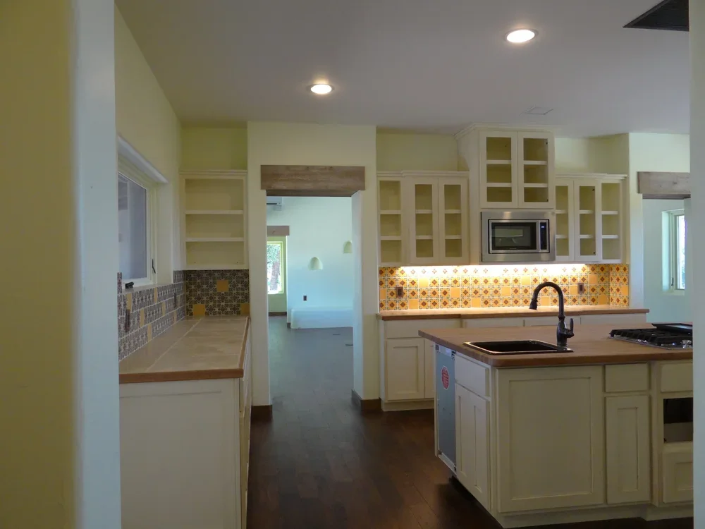 A modern kitchen featuring a sink, stove, and refrigerator, showcasing a functional and organized cooking space.