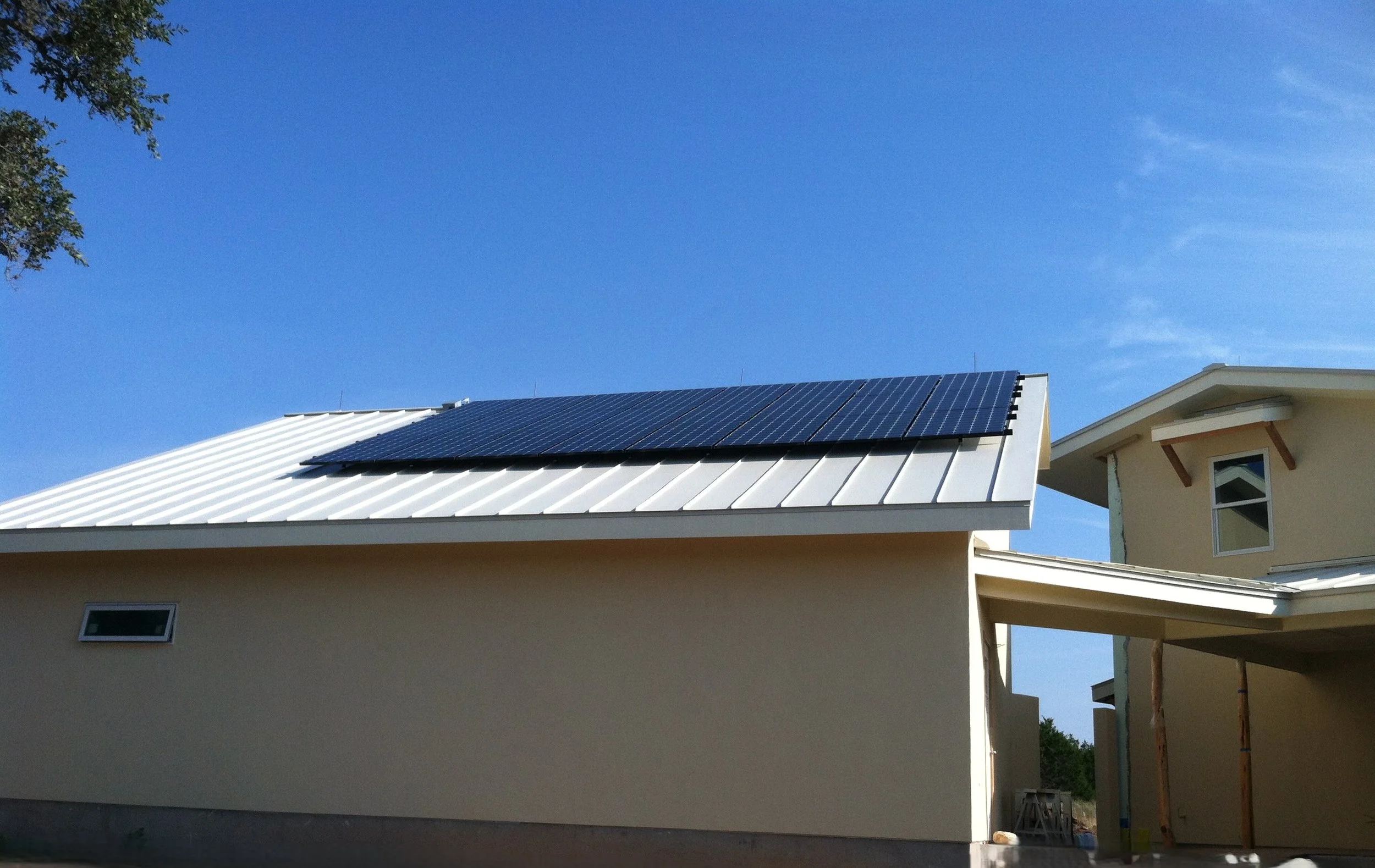 Solar panels installed on a residential roof in Texas, showcasing renewable energy use in a suburban setting.