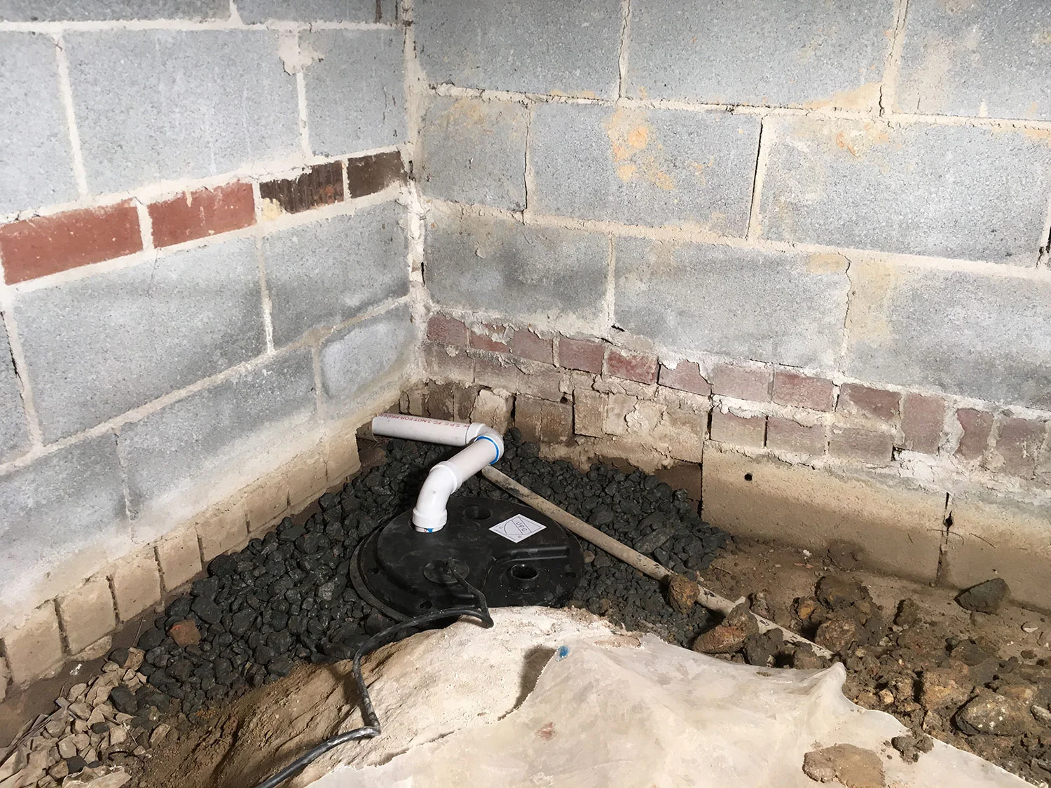 Newly installed sump pump in Carrboro, NC and sealed hole in foundation