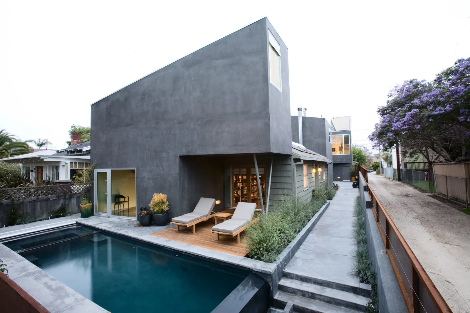 The project is comprised of three separate building which are added to an existing craftsman bungalow. Each building comprises a different use: Office (foreground), Living (middle), and Art Studio (rear)