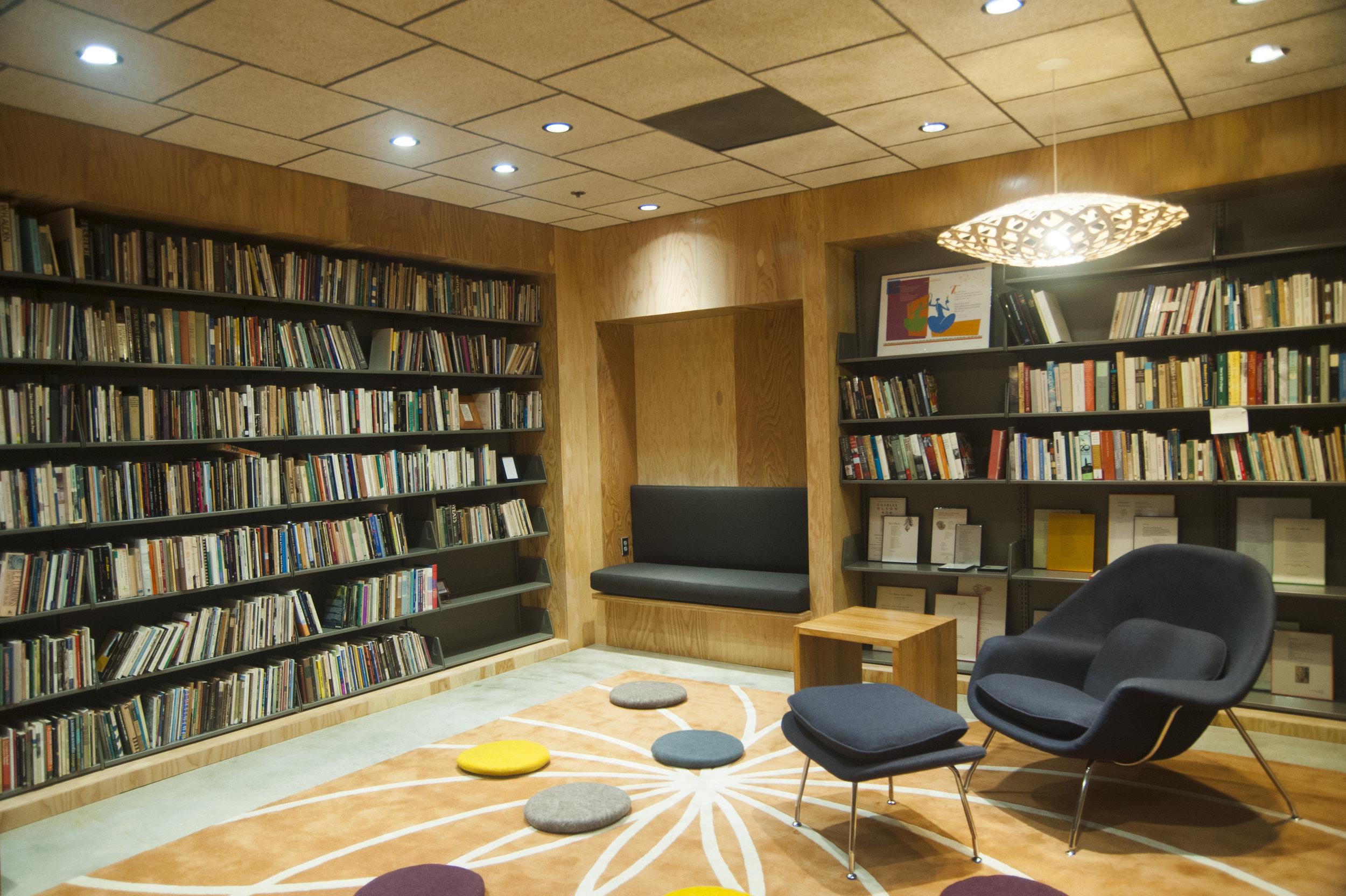 The plywood wrapper hosts a bench as well as the poetry collection.