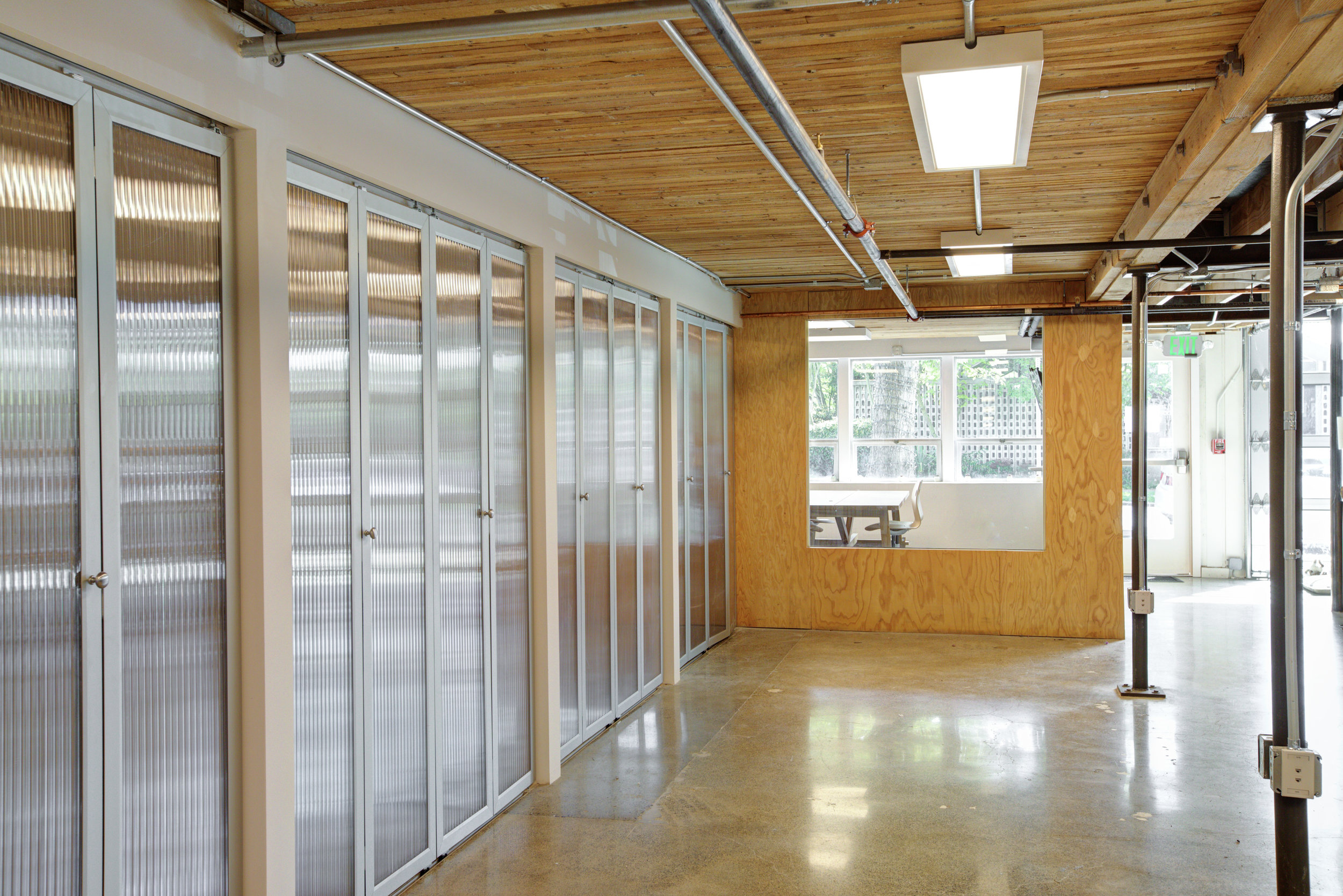 Looking towards the front towards a brightly lit meeting room.