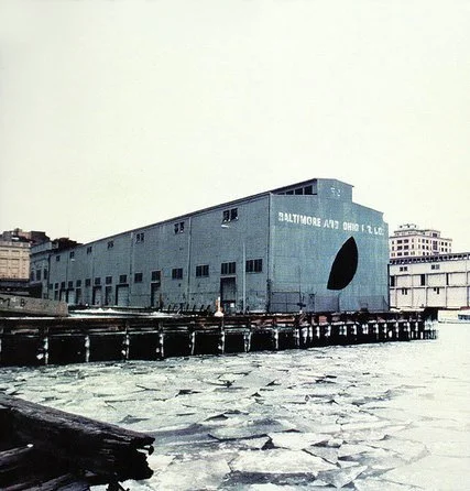 Manhattan’s Pier 52 shown in a photograph taken by the artist Gordon Matta-Clark, who sliced openings in the shed there to create his own artwork called “Day’s End.”CreditEstate of Gordon Matta-Clark, Artists Rights Society (ARS), New York