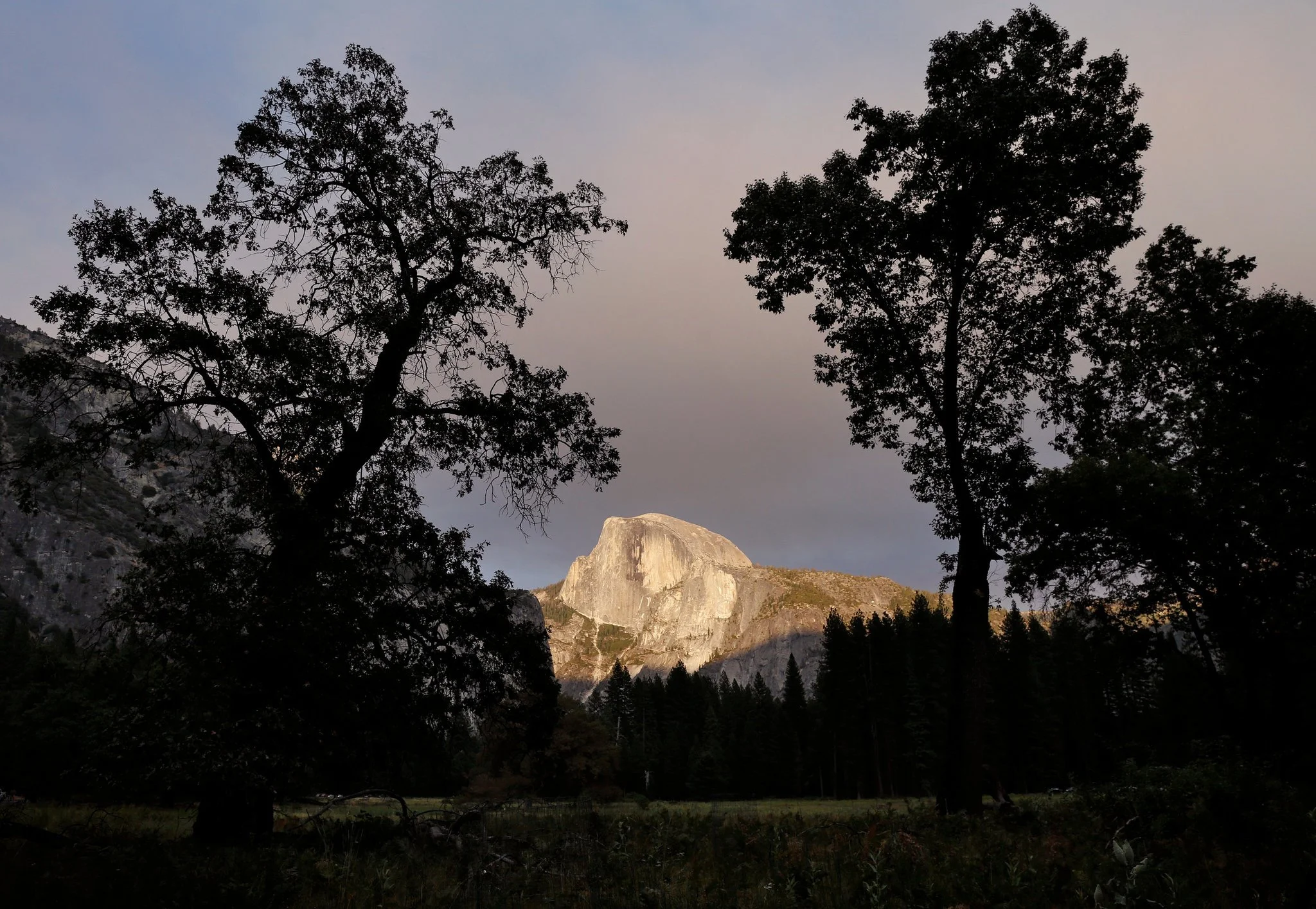 Half Dome at sunset, seen from the Yosemite Valley floor. CreditPreston Gannaway for The New York Times