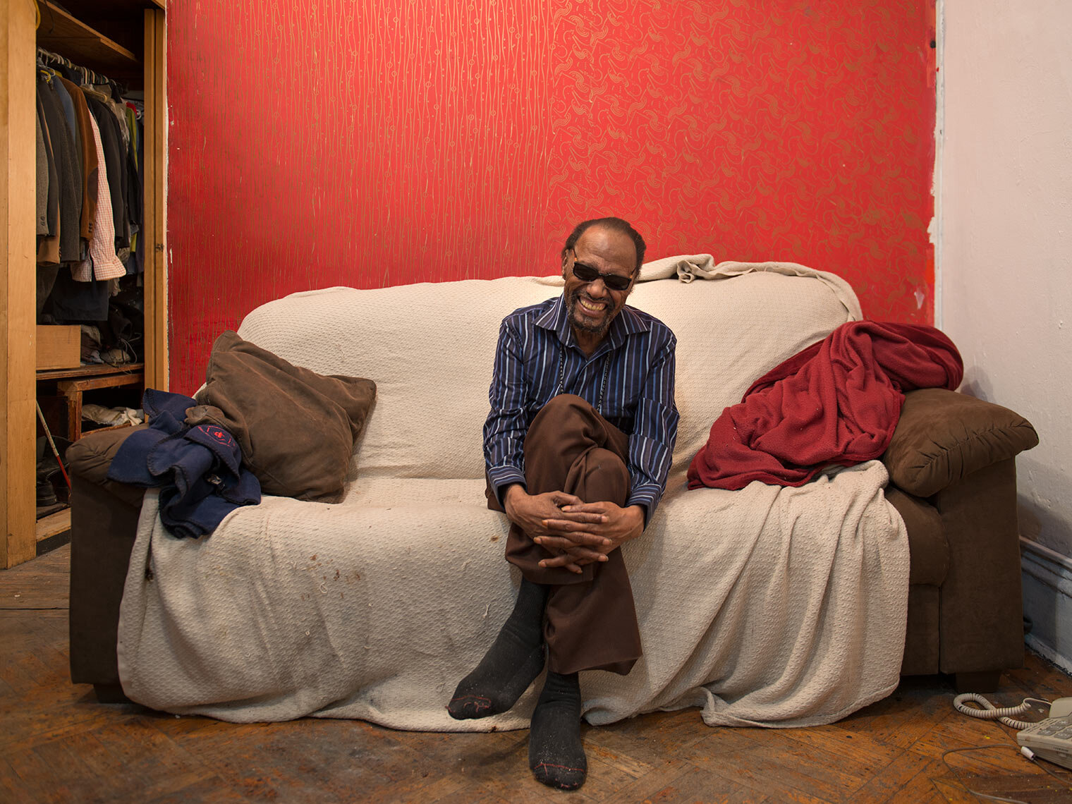 Steve cannon on covered couch with wall during eviction move out.jpg