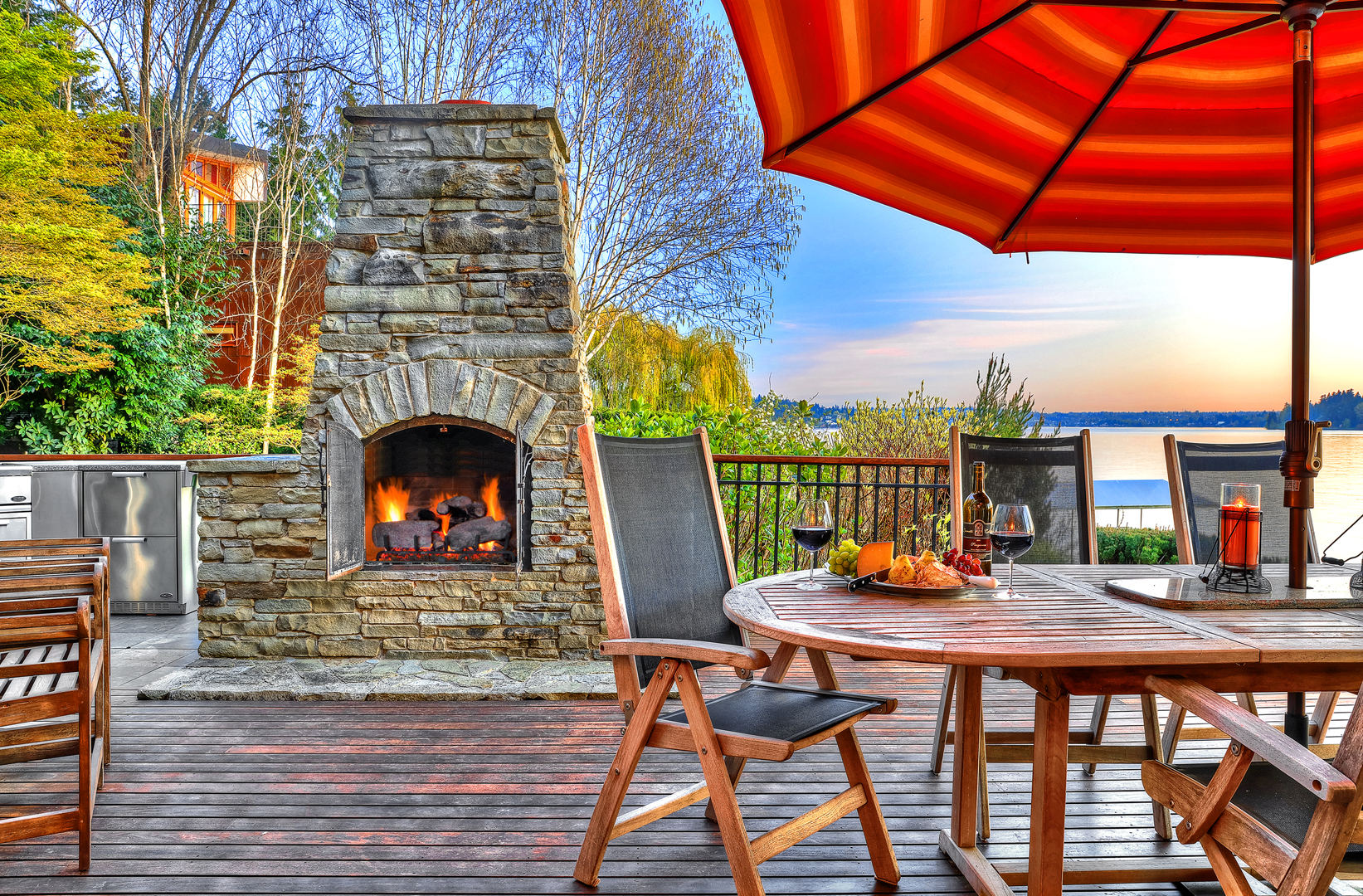 Photo of fireplace on back patio of lakefront PNW home designed by Seattle Residential Architect