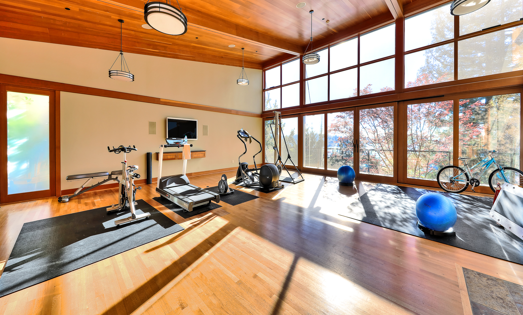 Photo of fitness room with high ceiling designed by a Seattle Residential Architect