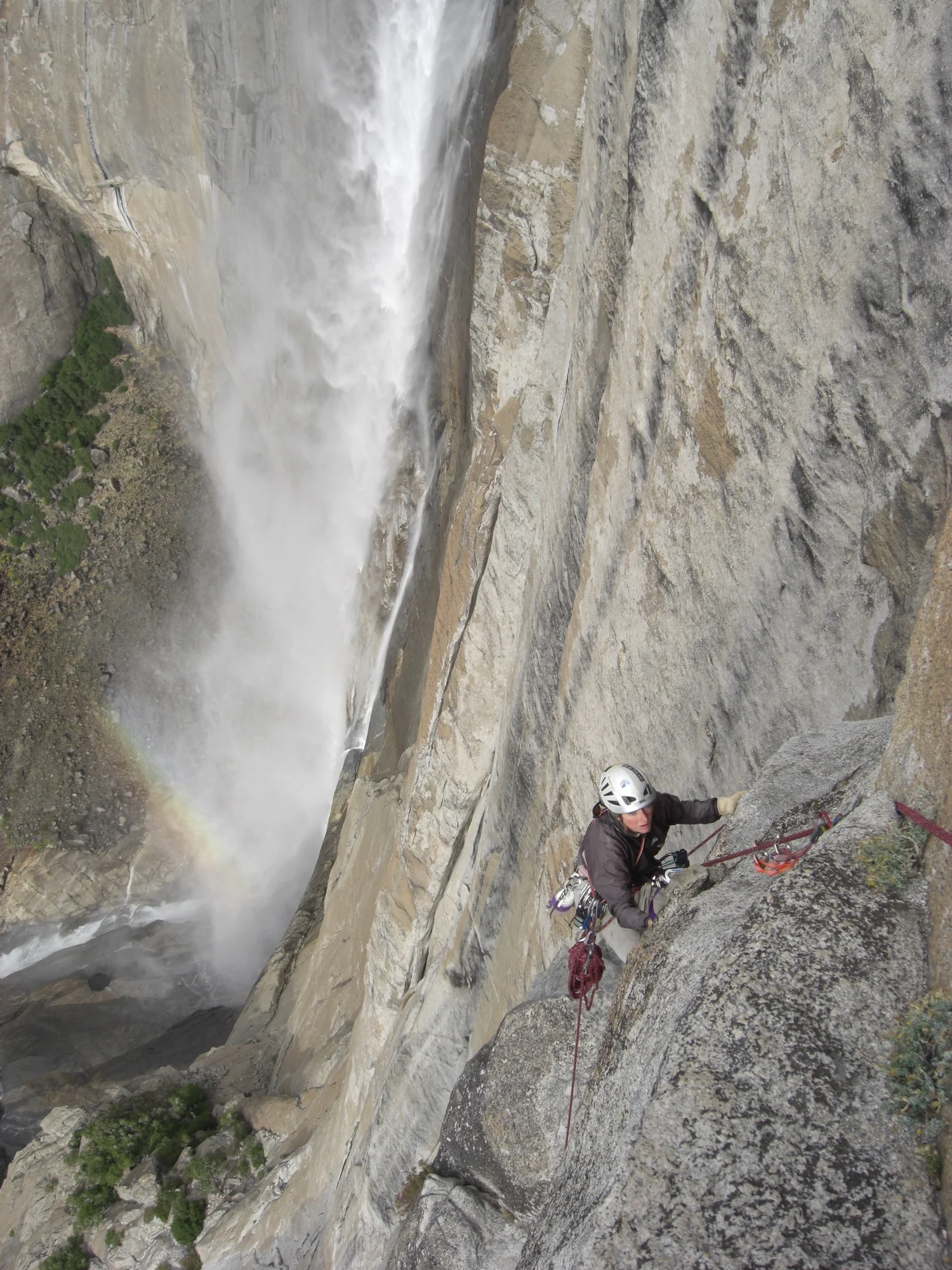 Lisa Van Sciver climbs Lost Arrow Spire Direct, Yosemite Falls in the background. Yosemite National Park, California. (Photo by Emily Stifler Wolfe)