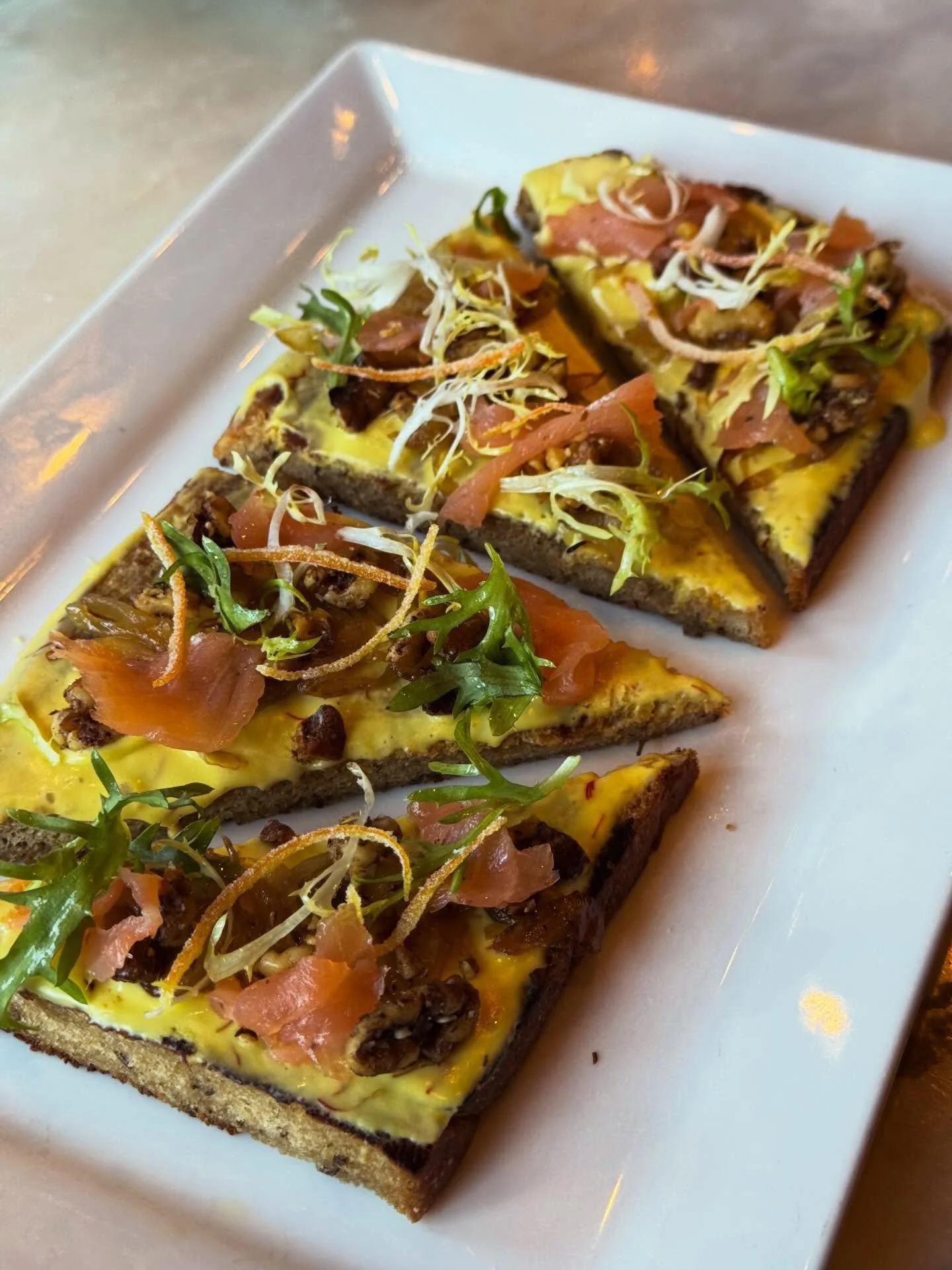 We&rsquo;re offering up a delightful appetizer this evening to get you started. It will be a Smoked Salmon Tartine on our house rye bread with honey-saffron goat cheese, za&rsquo;atar spiced walnuts, caramelized onions, fris&eacute;e and candied oran