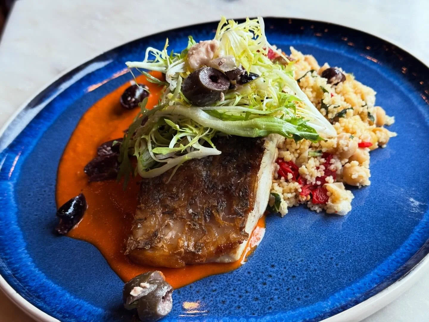 This evening's catch: Seared Barramundi over warm couscous salad with chickpeas, roasted red peppers &amp; sun-dried tomatoes, crema rosa, and olive salad. Book your table through OpenTable or by calling (859) 252-1010

#dudleysonshort #local #visitl