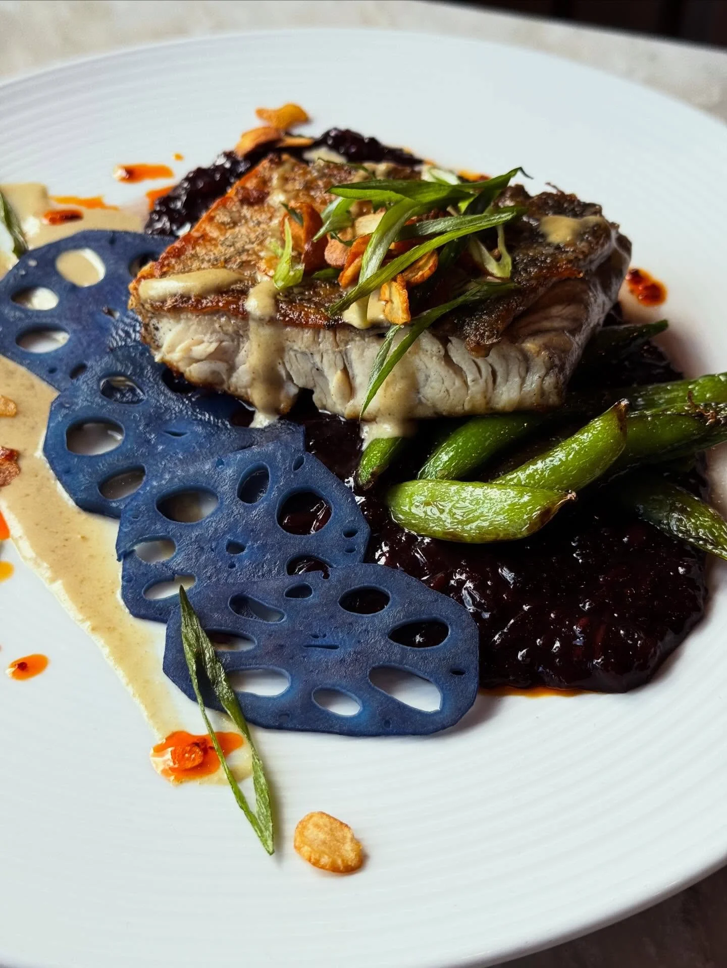 Chef Hannah&rsquo;s fish special tonight is Seared Barramundi over purple sticky rice porridge with snap peas, lavender pickled lotus root, yuzu kosho, fried garlic &amp; green onion. Make a reservation through OpenTable or by calling us at (859) 252