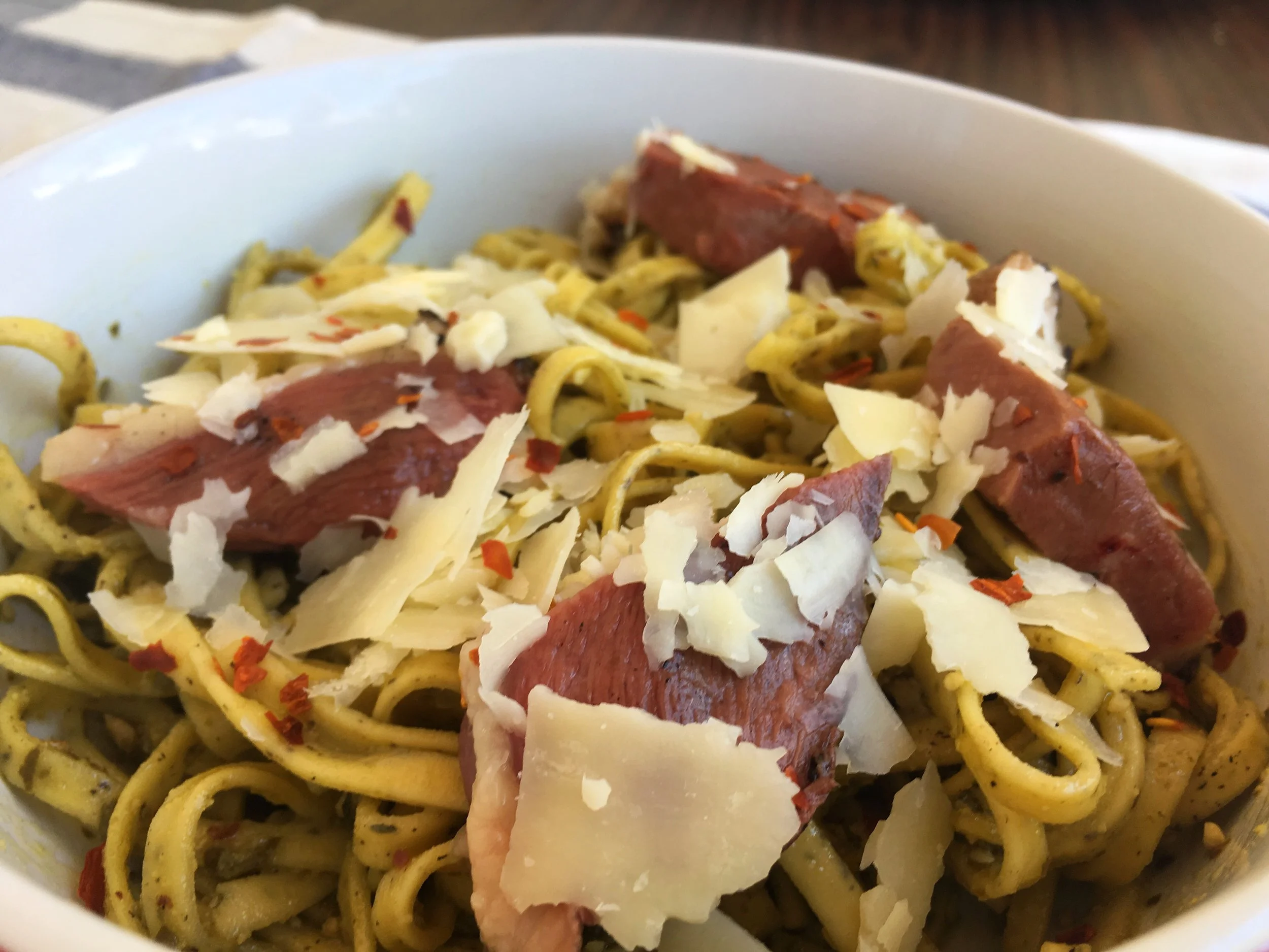 fettuccine with freshly grated parmesan, grilled duck breast, pesto, red pepper flakes and mushrooms.