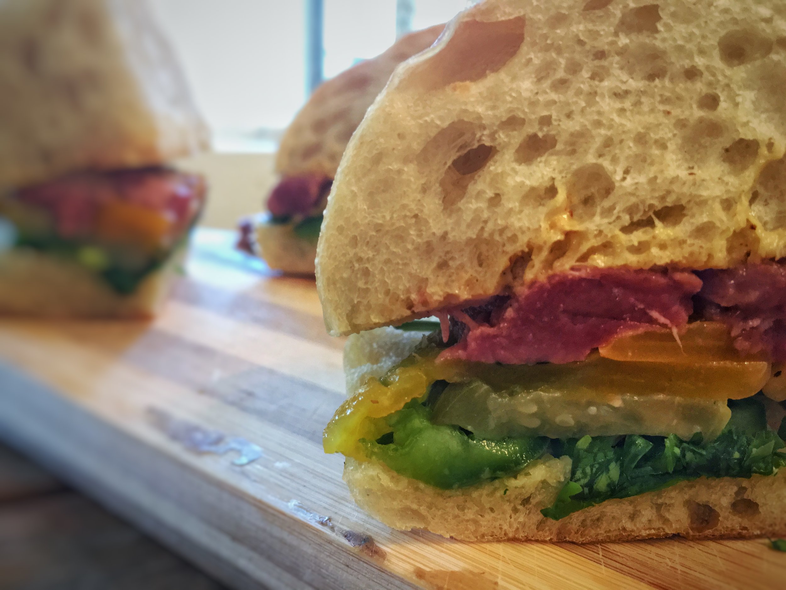 DUCKCHAR Moulard Duck Breast Sandwich with grilled duck breast, jalapeno, spicy mustard, cilantro, and spicy pickles on ciabbatta 